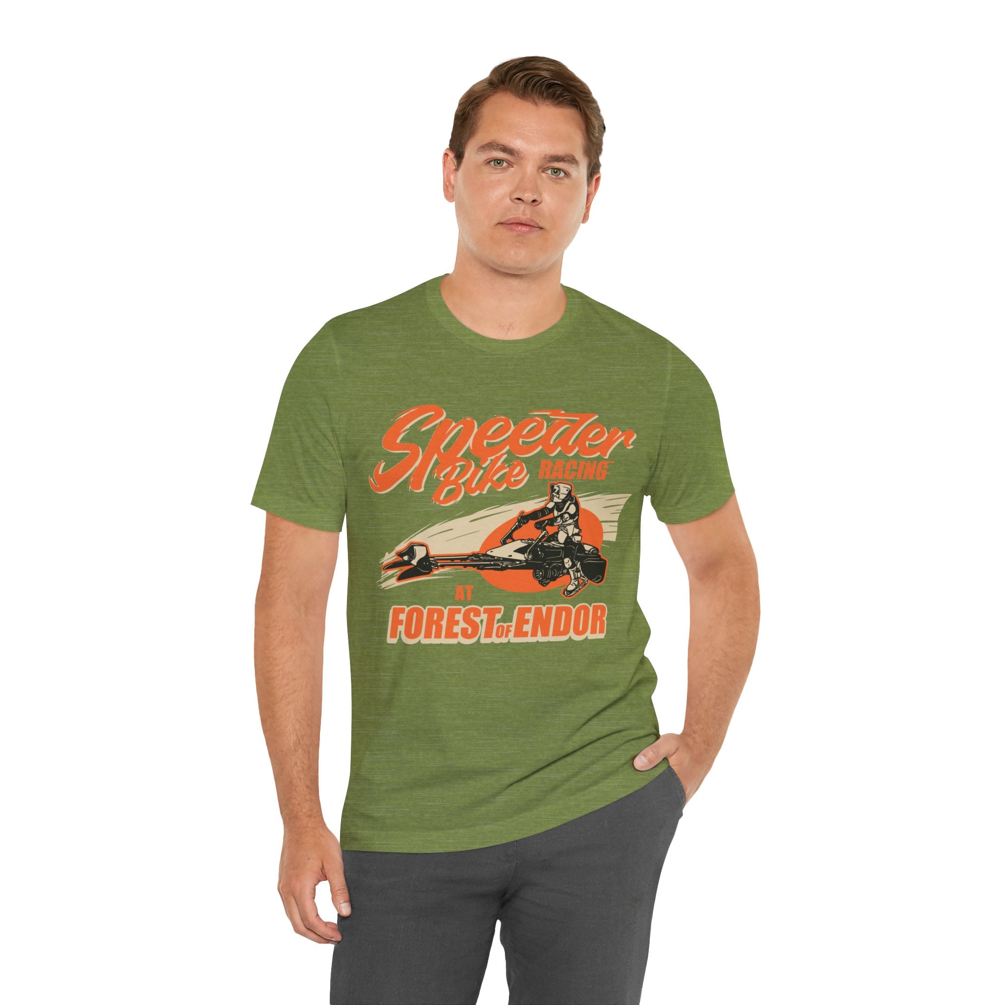 Sentence with Product Name: A man wearing a green jersey tee with a Speeder Bike Racing graphic print, standing against a plain background.
