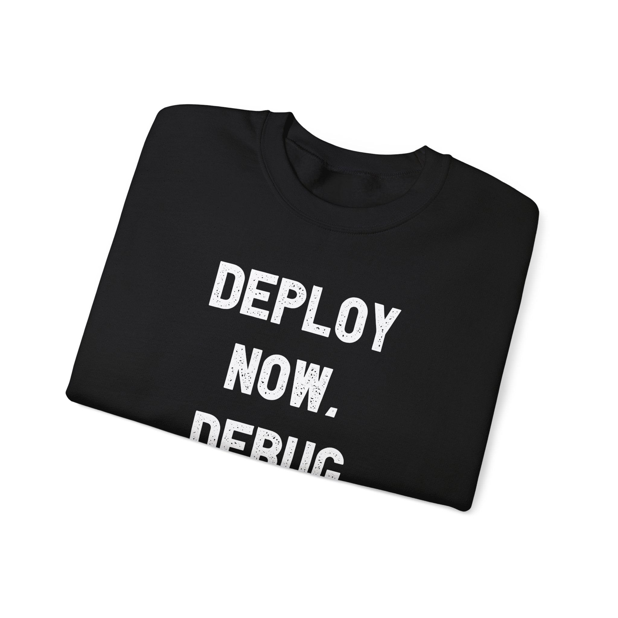 Folded neatly, the "Deploy Now, Debug Later" sweatshirt in black with white text is the perfect addition for tech enthusiasts as they prepare for the colder months.