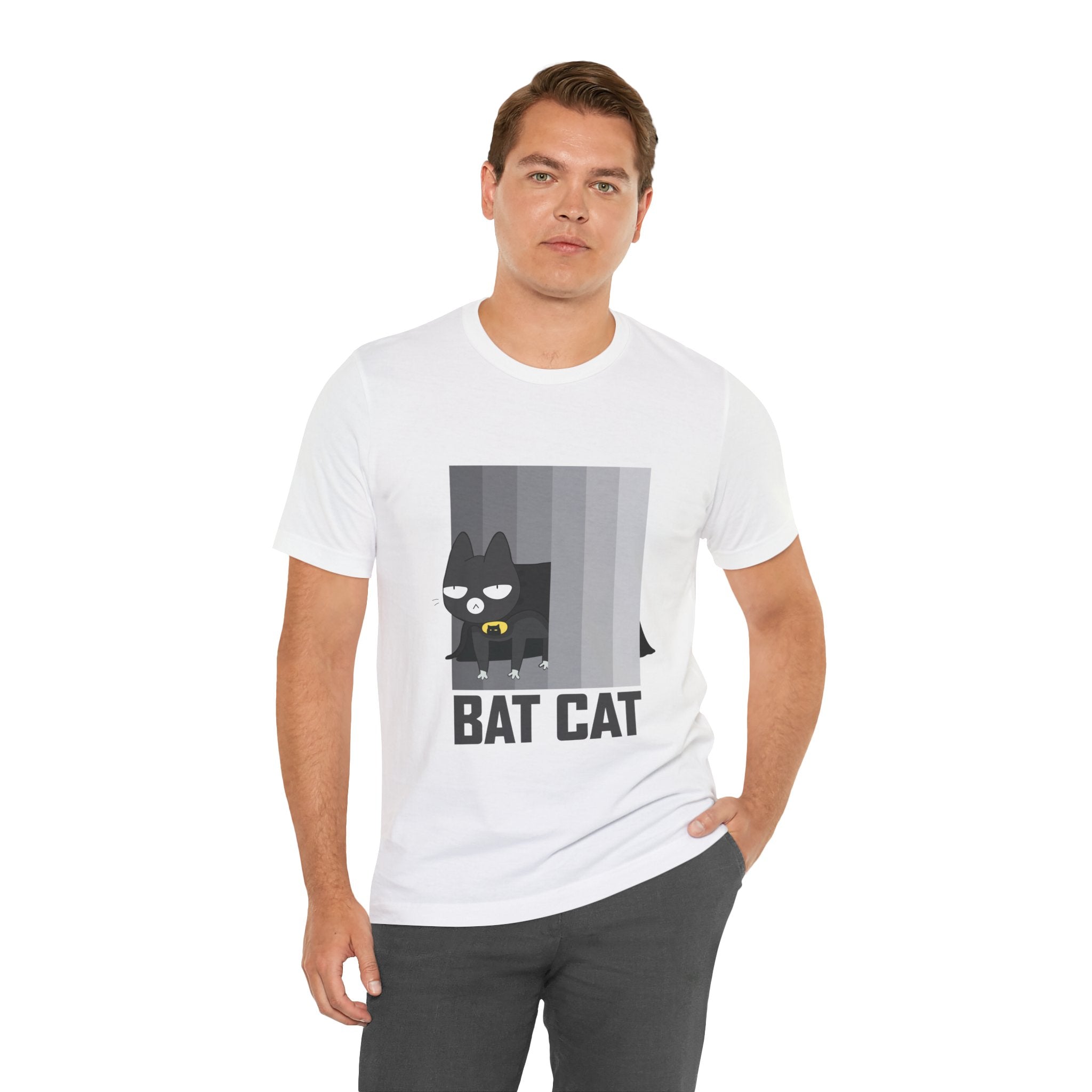 Man standing in a studio, wearing a BATCAT T-Shirt with a "Batcat" cartoon design.