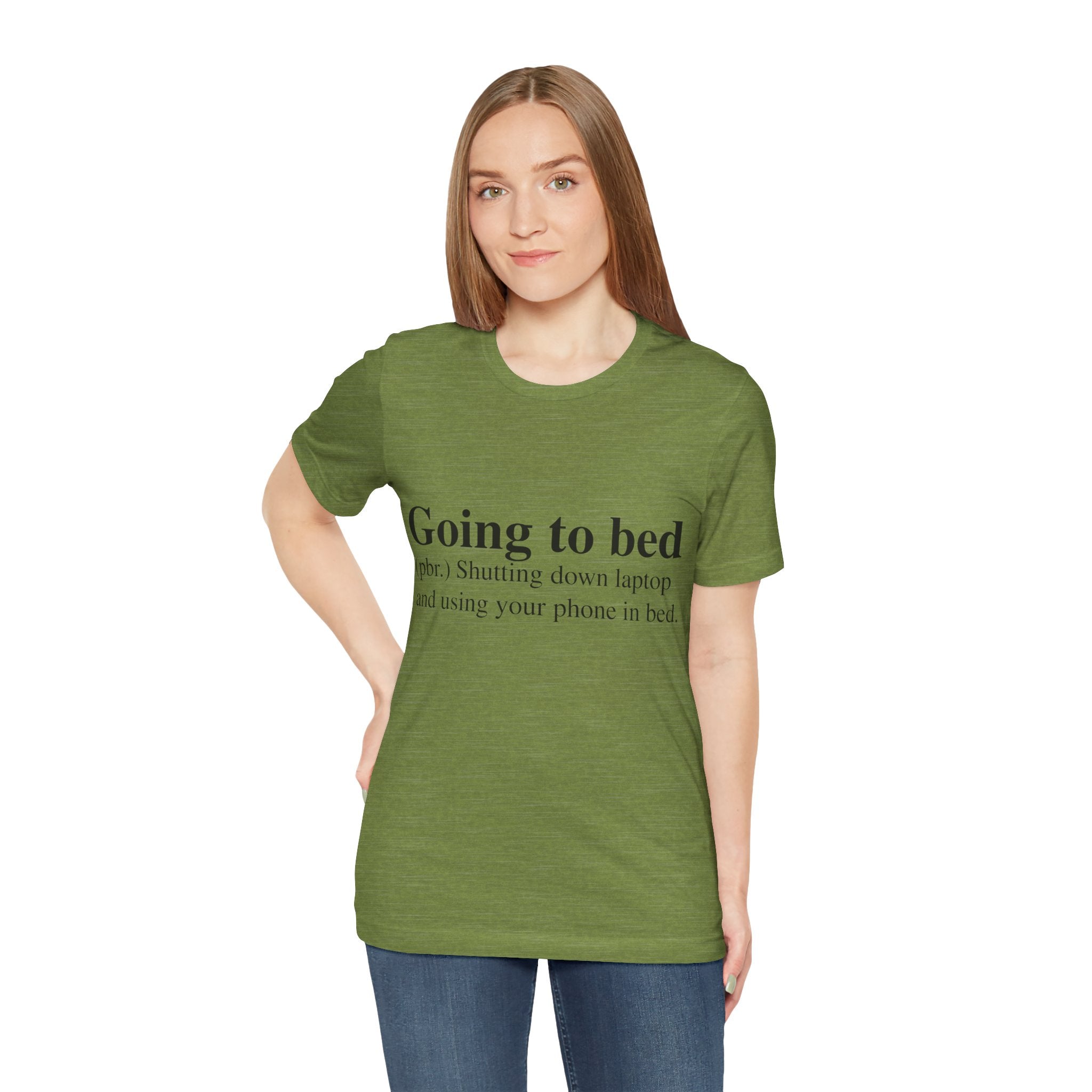 Woman in a green Going to Bed T-Shirt with text, "going to bed (n): shutting down laptop and not using your phone in bed," standing against a white background.
