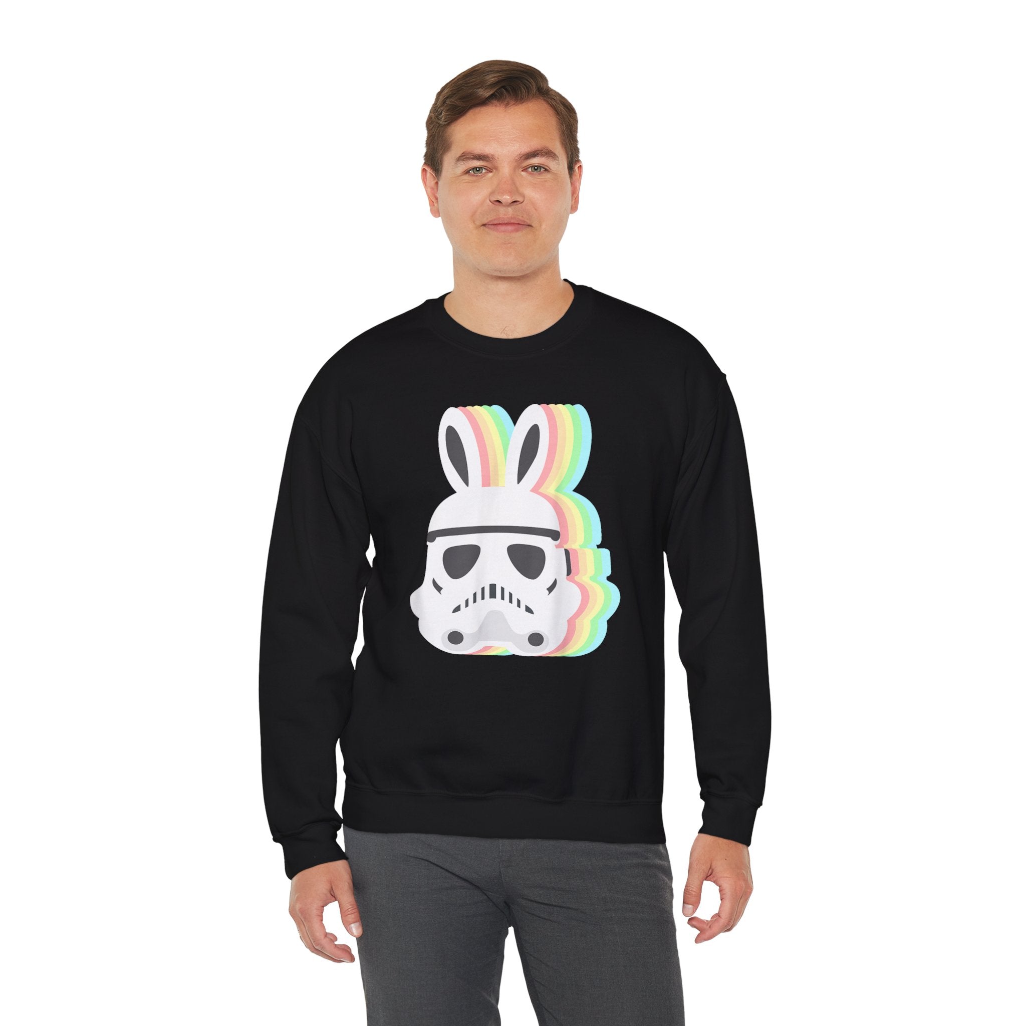 A man wearing a black Star Wars Easter Stormtrooper - Sweatshirt, with its helmet adorned with rainbow bunny ears.