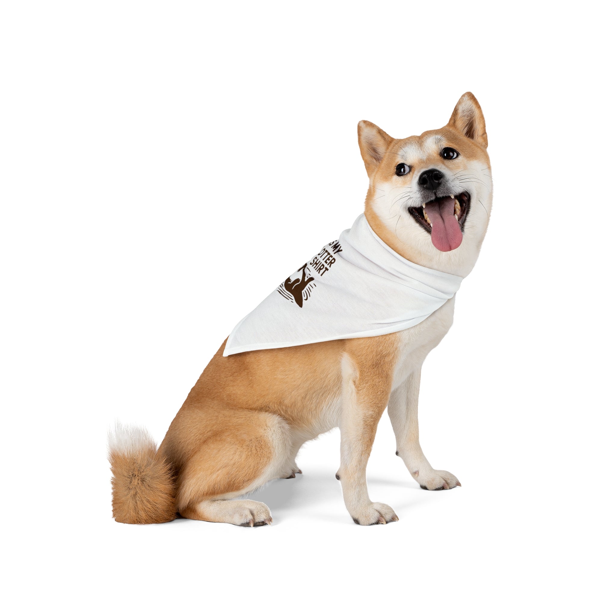 A dog with a tan and white coat is sitting and wearing a My Otter Shirt - Pet Bandana. The dog is looking to the side with its mouth open and tongue out.