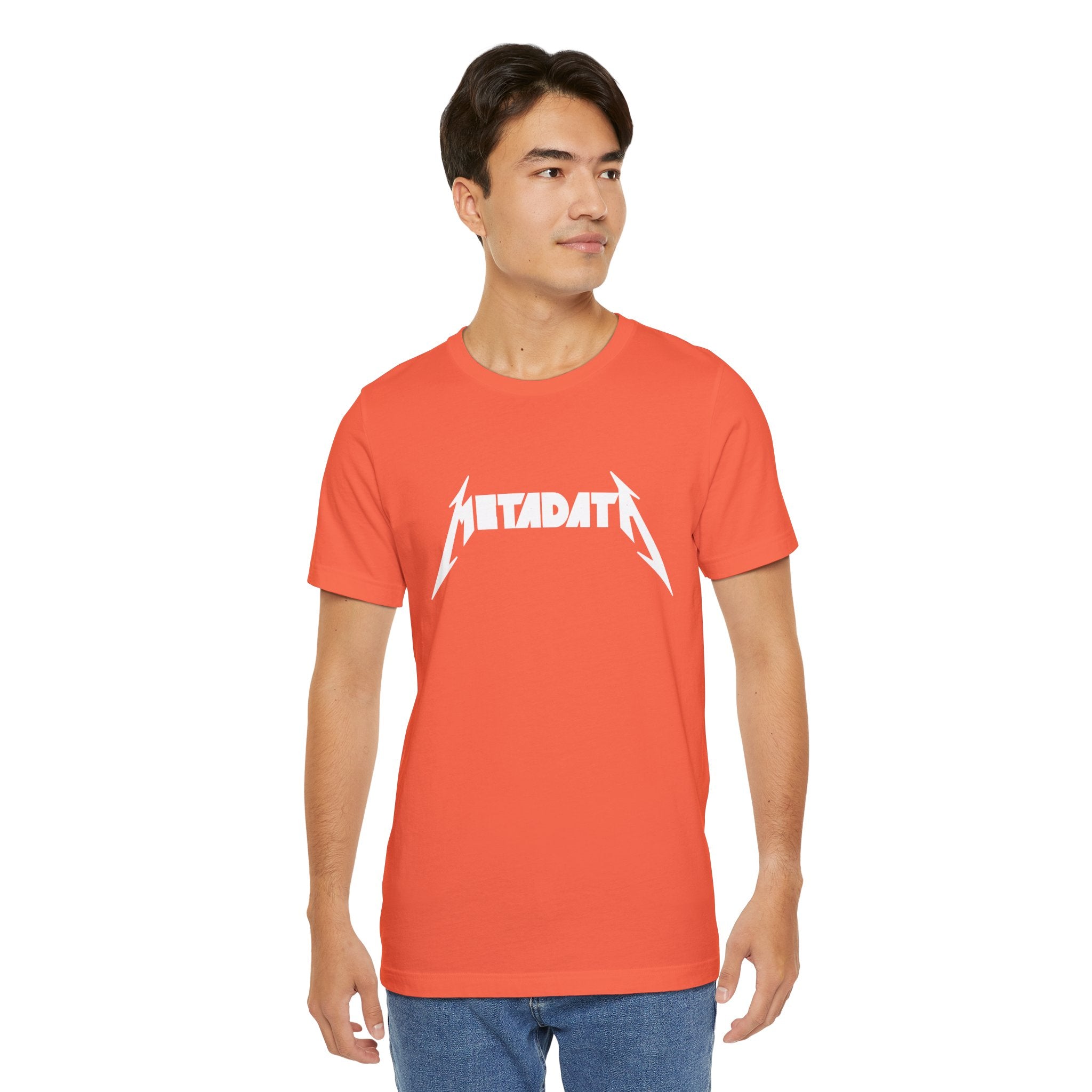 A person wearing the Metadata T-Shirt, crafted from red Airlume combed, ring-spun cotton and featuring white text, stands against a plain background.