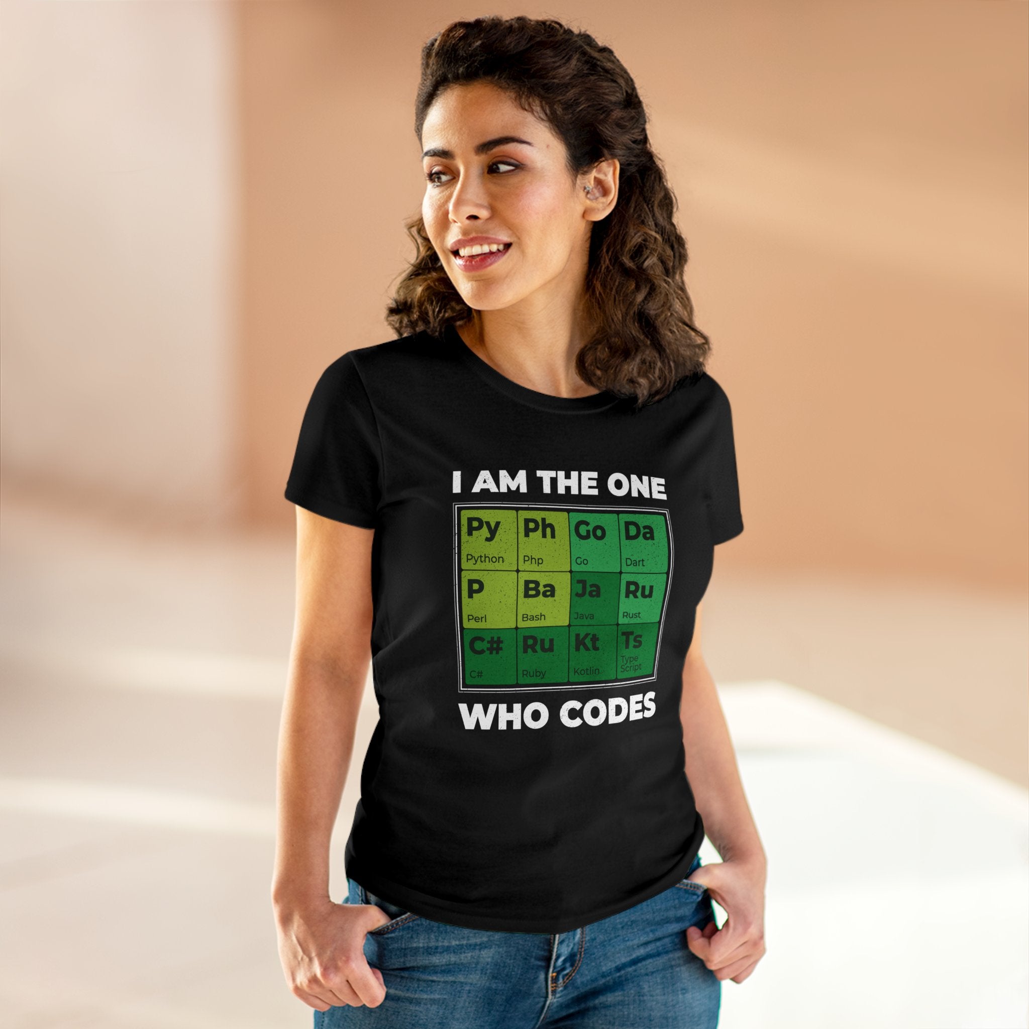 Person wearing a Developer Periodic Table - Women's Tee that exudes geek chic, featuring the text "I AM THE ONE WHO CODES" and code syntax elements displayed in a Developer Periodic Table design.