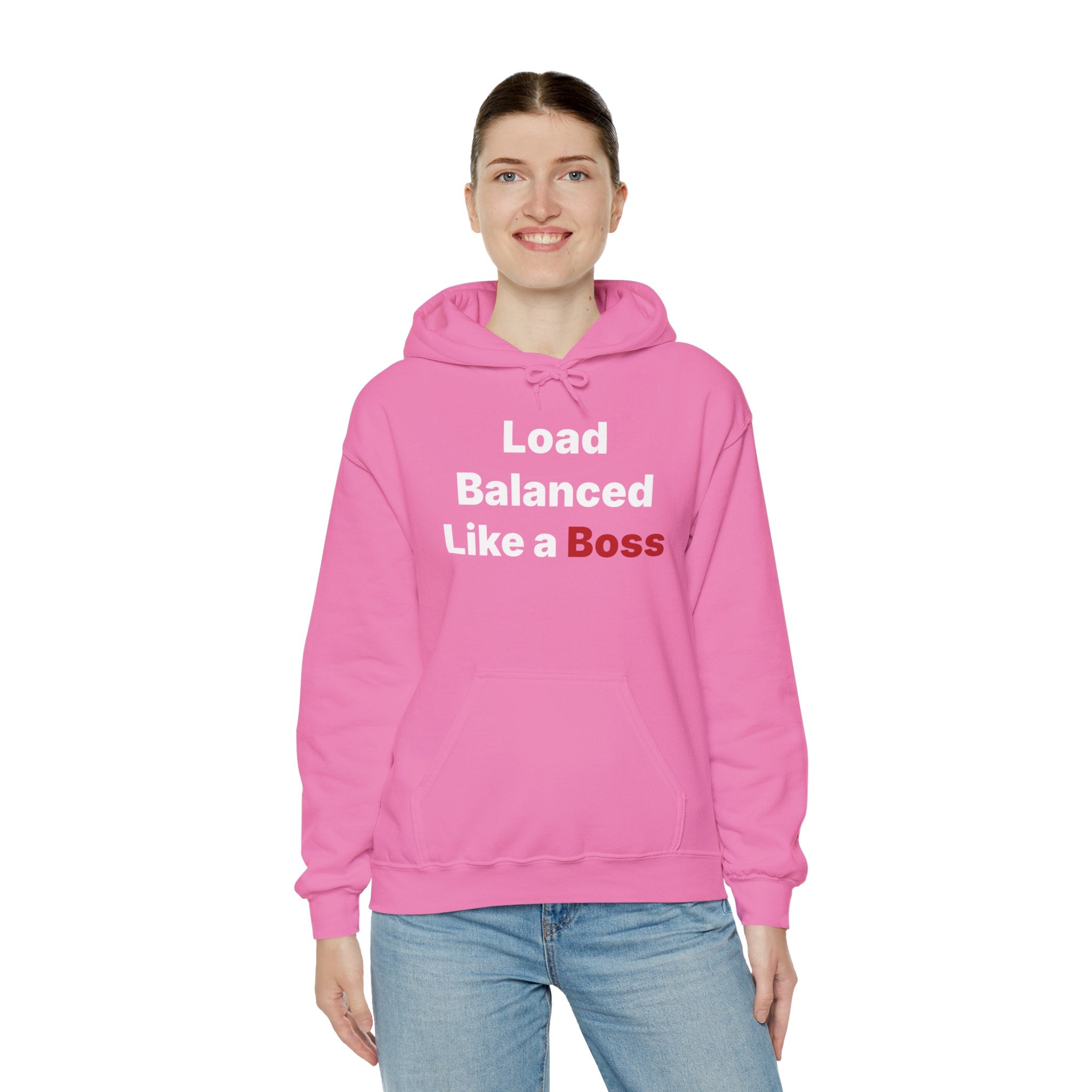 A person grins while wearing the "Load Balanced Like a Boss" hooded sweatshirt in a classic fit, set against a plain background.