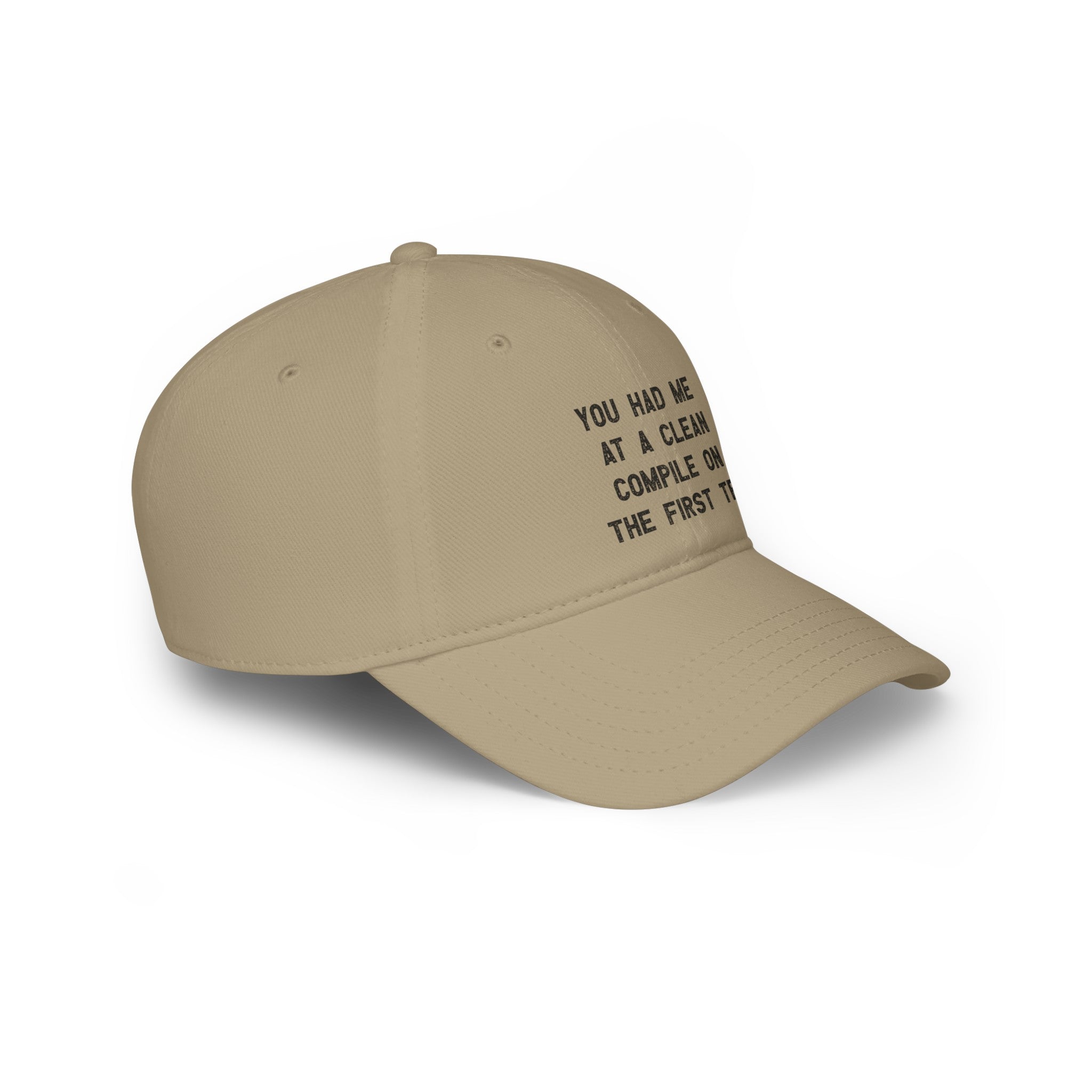 A beige baseball cap with black text reading, "You Had Me At a Clean Compile on the First Try," this "You Had Me At a Clean Compile on the First Try - Hat" boasts durable stitching for long-lasting wear.