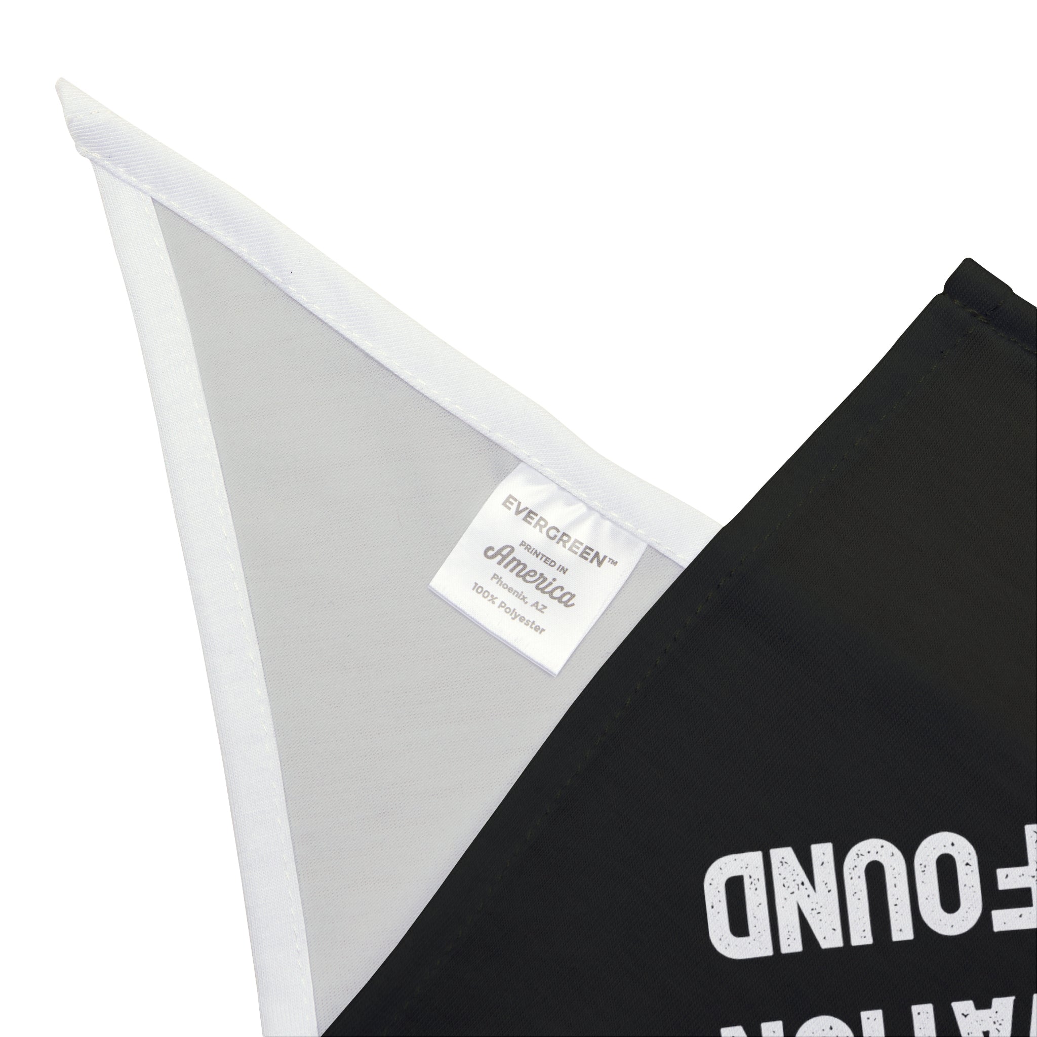 Close-up of an "Error 404: Motivation not found - Pet Bandana" tag on a black and white triangular flag made from soft-spun polyester with partial text visible, offering pet-friendly comfort.
