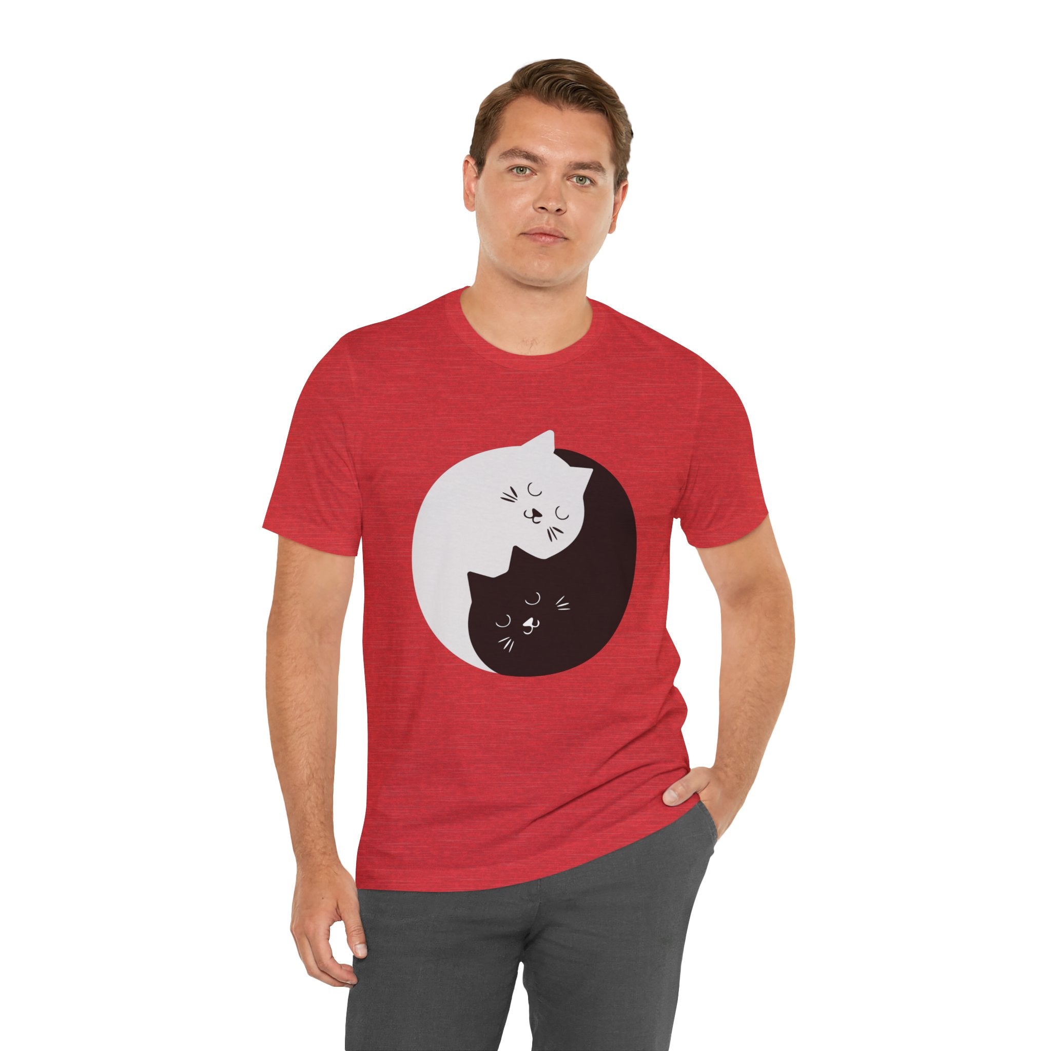 Man in red YING- ANG KITTIES T-Shirt featuring a graphic of Ying & Yang Kitties, standing against a plain background.
