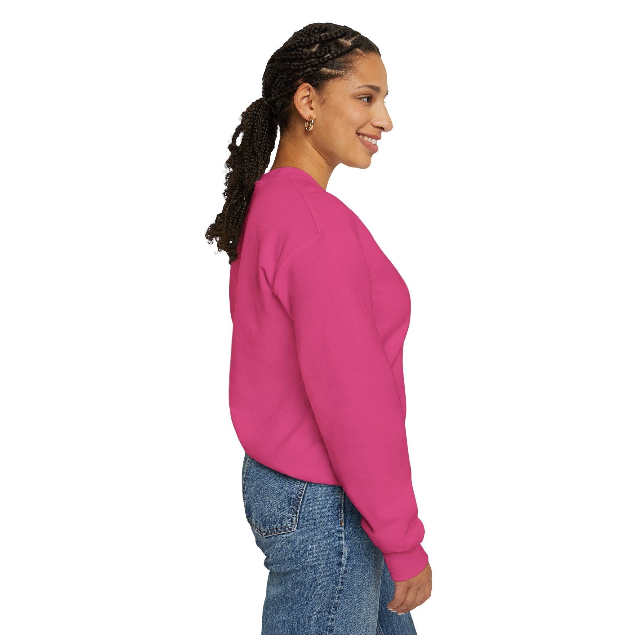 A woman wearing the "Deploy Now, Debug Later" sweatshirt in pink and blue jeans stands sideways, smiling warmly against a plain white background, as she prepares for the colder months.