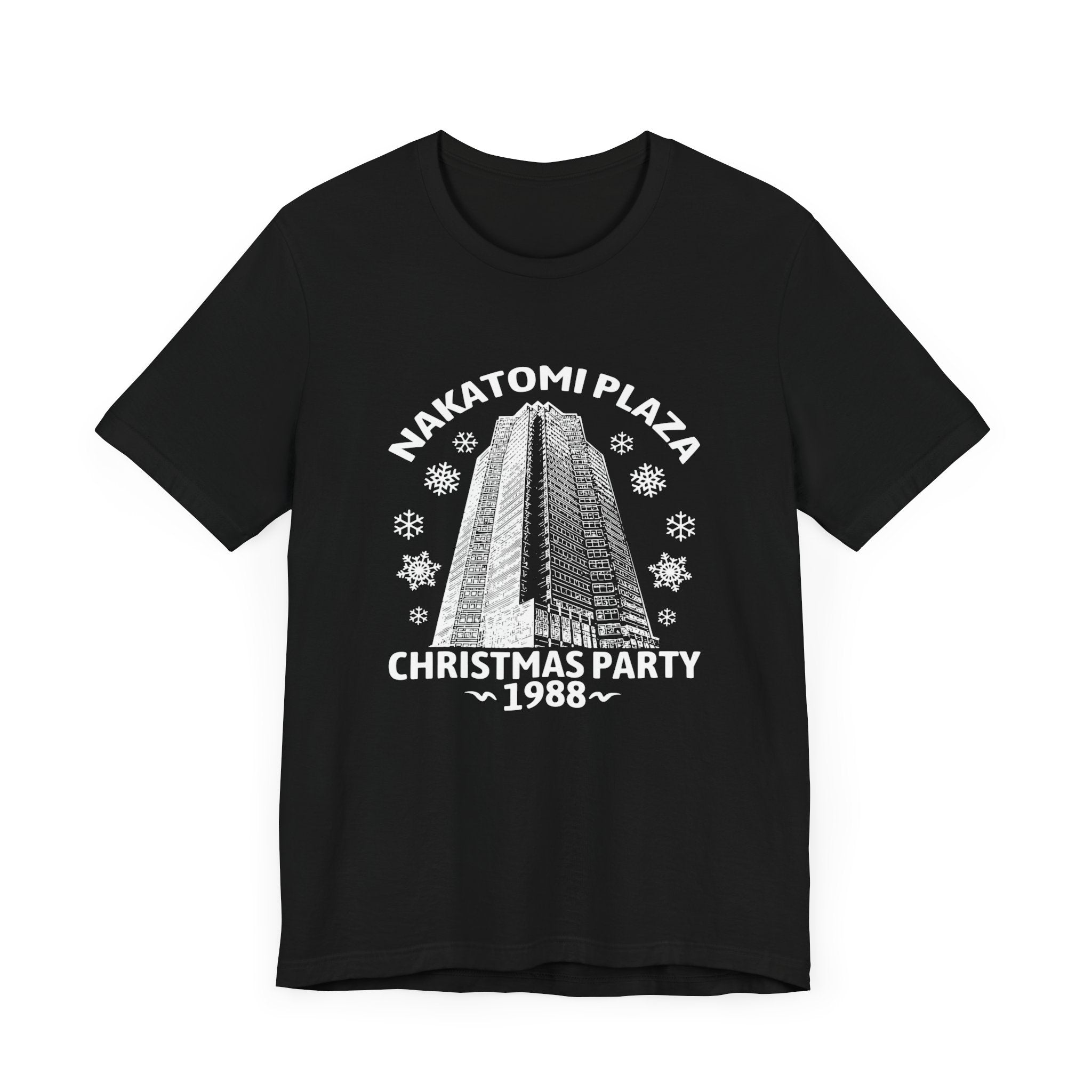 Unisex jersey tee with a graphic of Nakatomi Plaza and the text "Nakatomi Plaza Christmas Party 1988" surrounded by snowflakes.