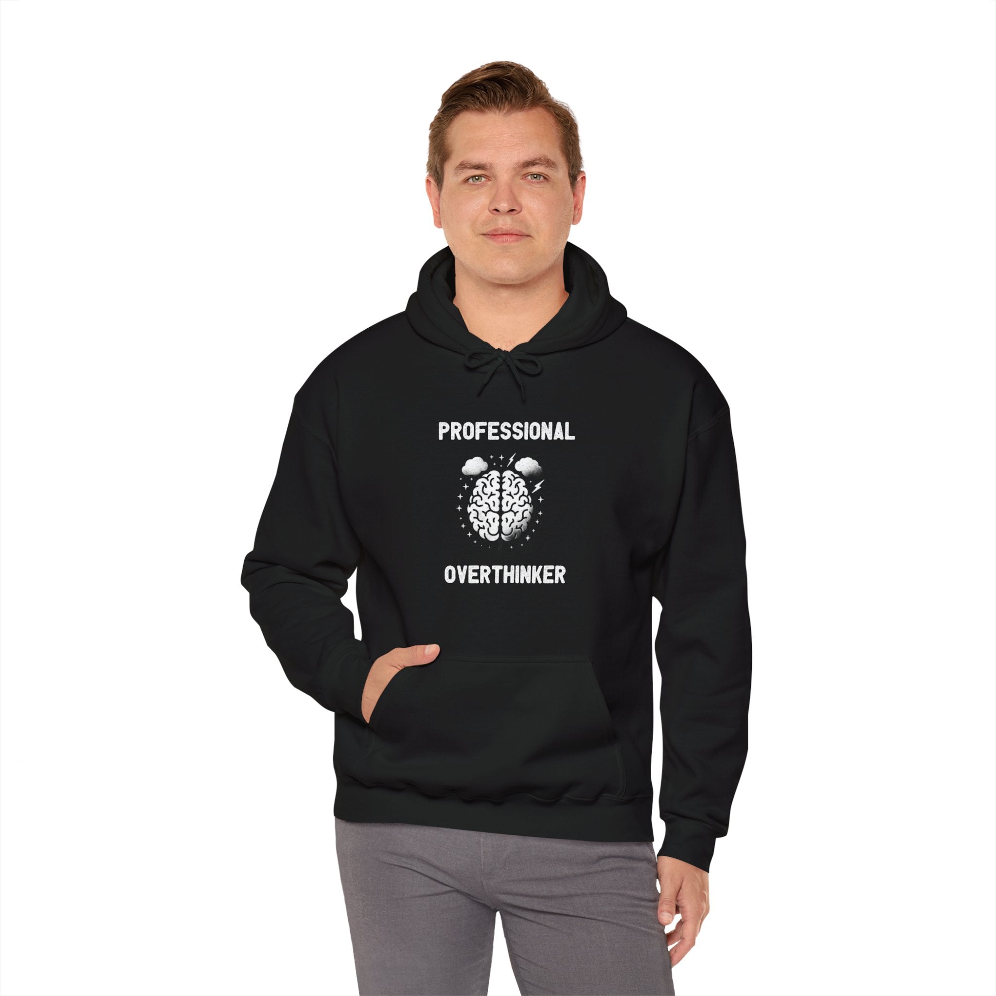 A person stands wearing a black Professional Overthinker - Hooded Sweatshirt that boasts the "Professional Overthinker" design with an illustration of a brain on the front, combining style and comfort.