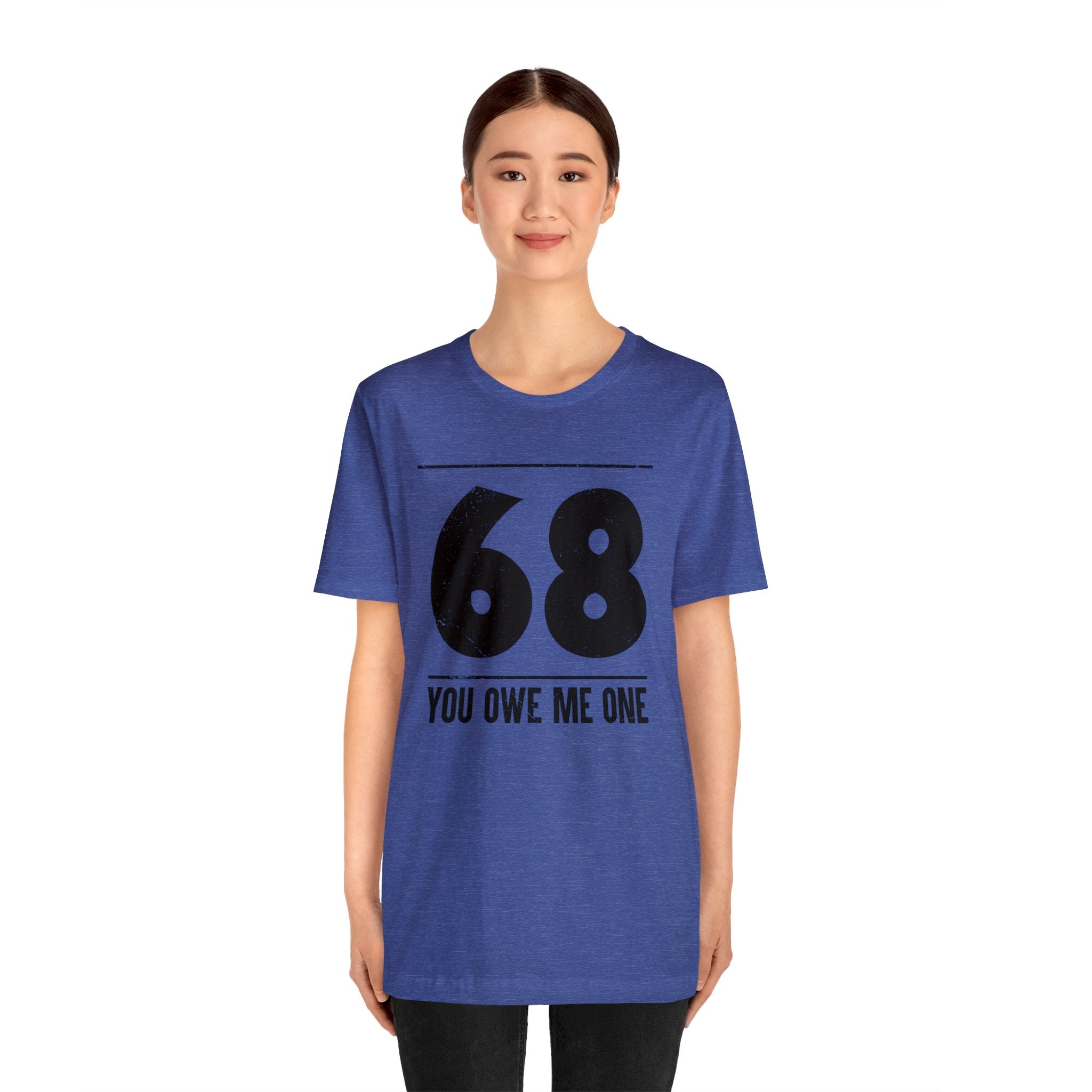 A woman wearing a geeky t-shirt that says "68 You Owe Me One" - an awesome deal.