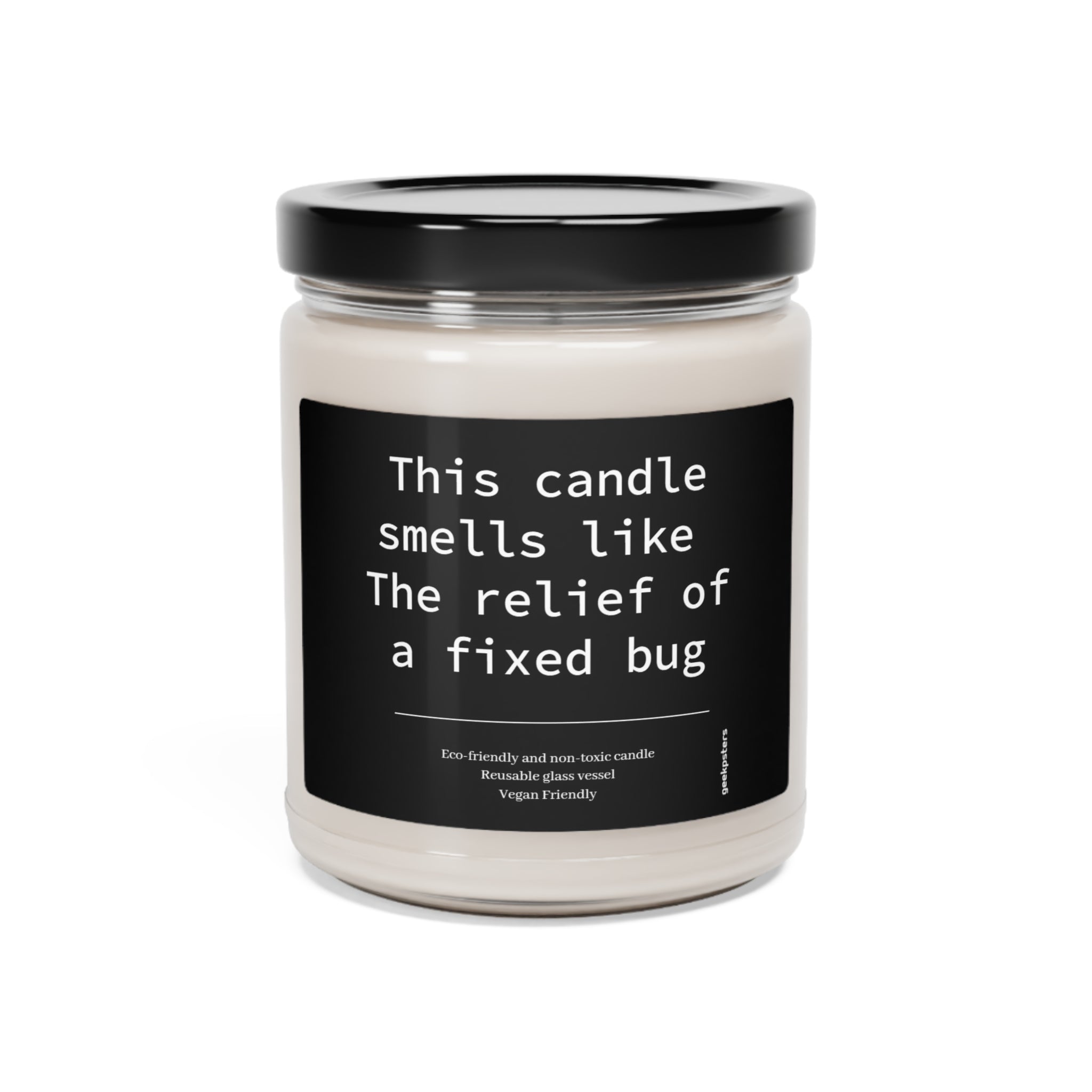 A This Candle Smells Like The Relief of a Fixed Bug soy candle in a clear jar with a label that reads "this candle smells like the relief of a fixed bug," indicating it's eco-friendly and vegan.