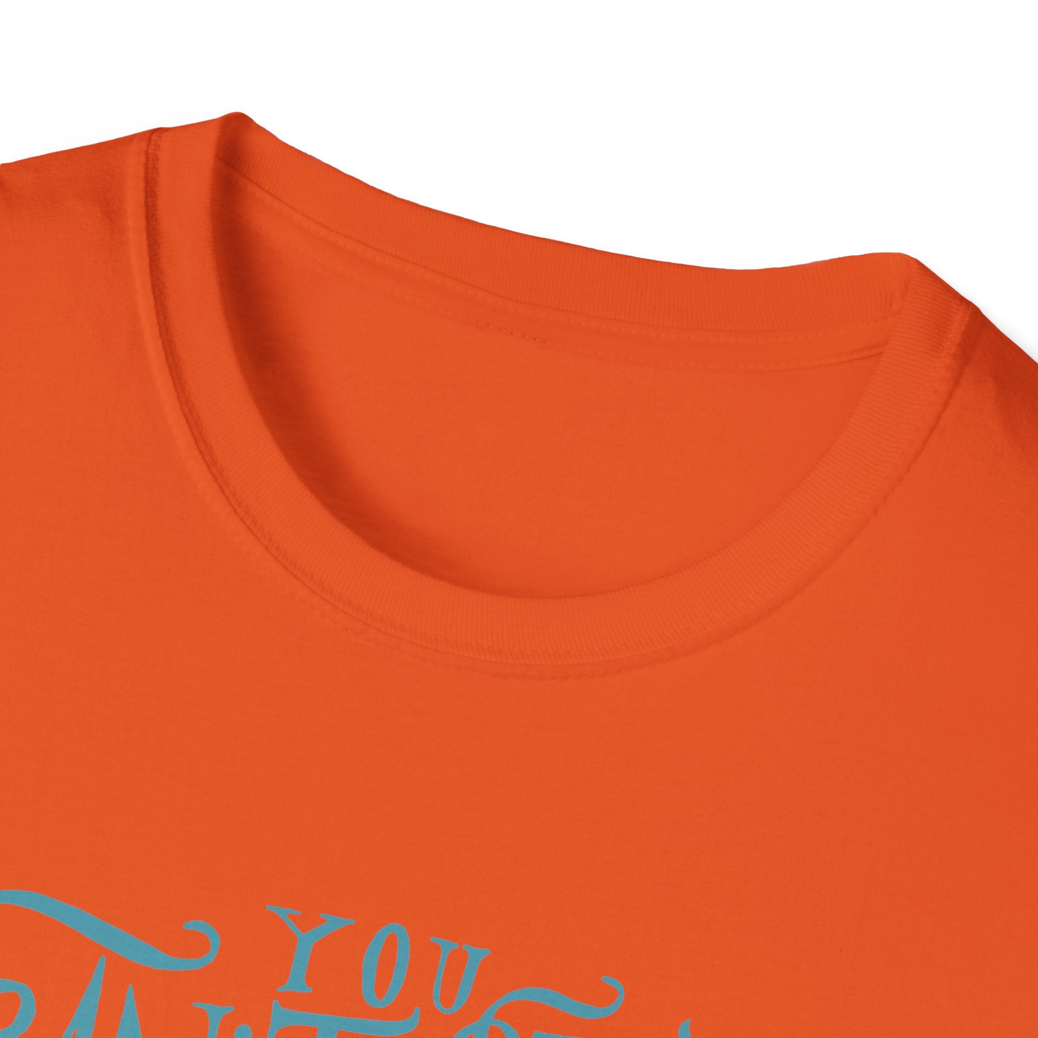 A detailed view of the Can't Stop Surfing T-Shirt showcases an orange garment with a vintage-inspired design and partially visible blue cursive text at the bottom.