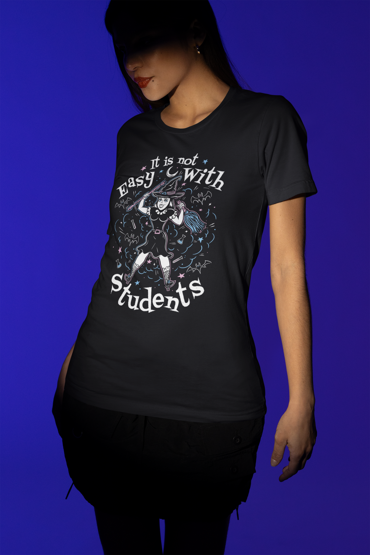 'It Is Not Easy With Students' witch t-shirt in black, woman modeling it, funny teacher gift shirt