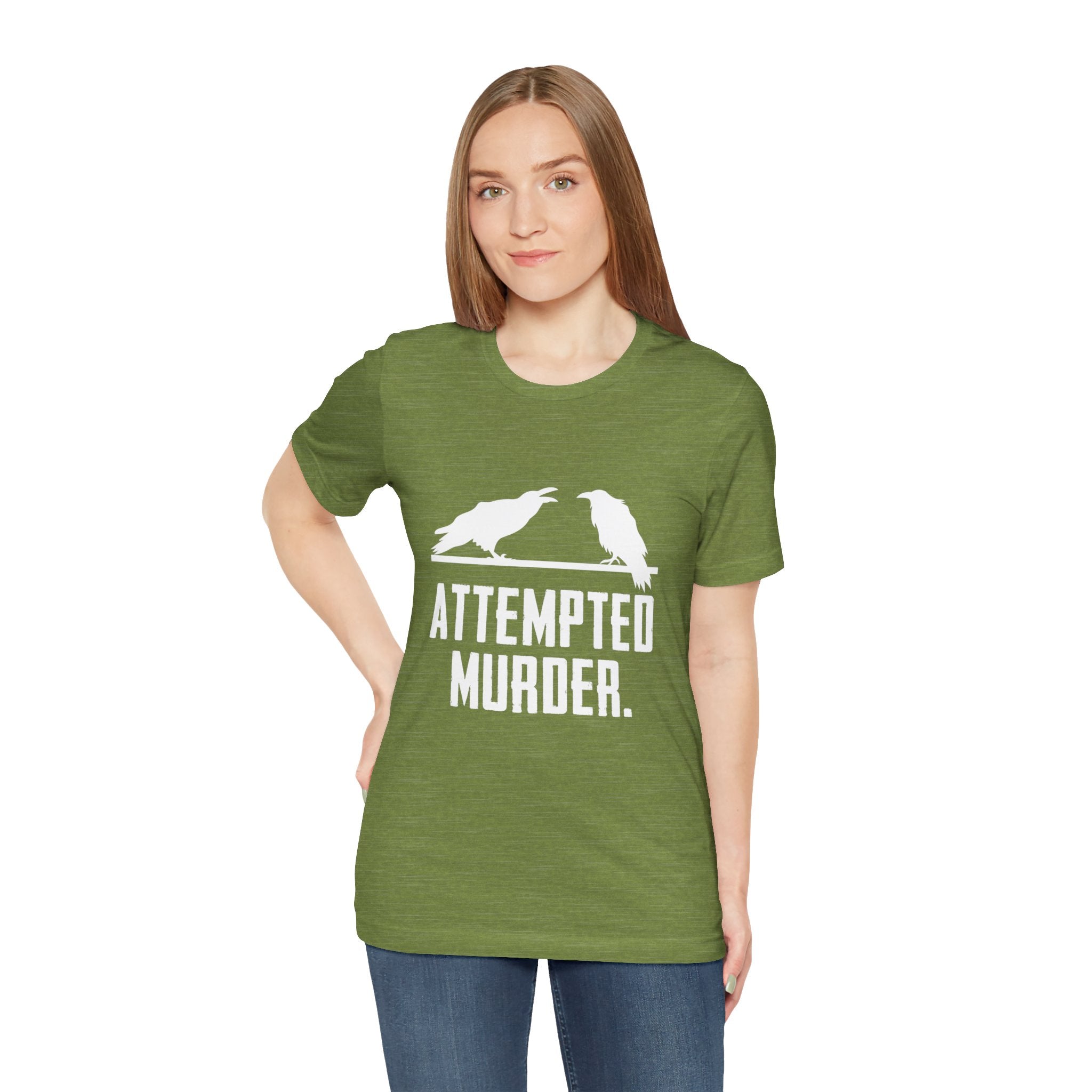 A person sporting the trendy Attempted Murder T-Shirt, featuring a stylish green hue with two birds and the witty text "Attempted Murder," creates an amusingly clever scene.