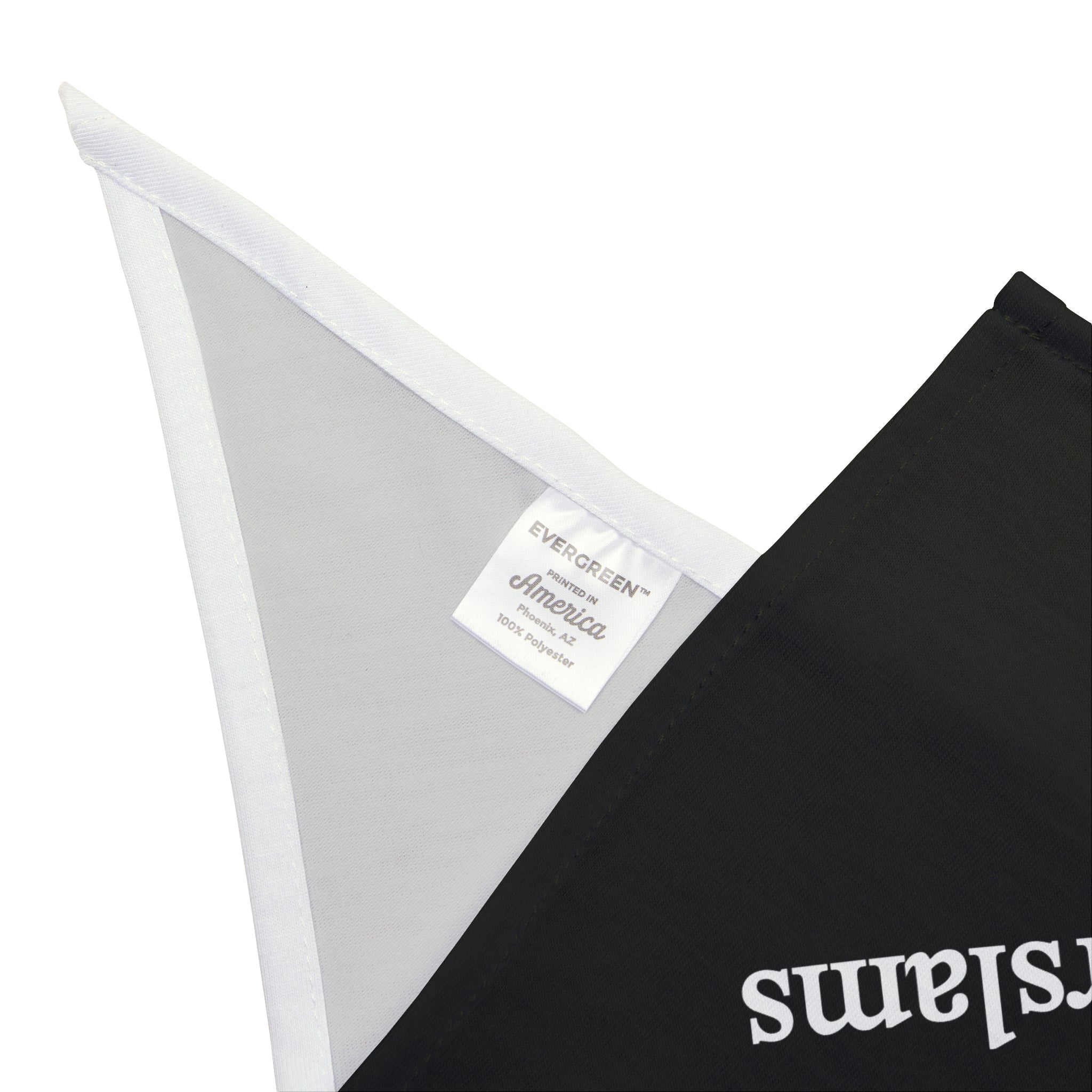 A close-up of a fabric label reading "Evergreen America" attached to the edge of a soft-spun polyester black pet bandana, featuring the design "Fewer PowerPoints More Powerslams.