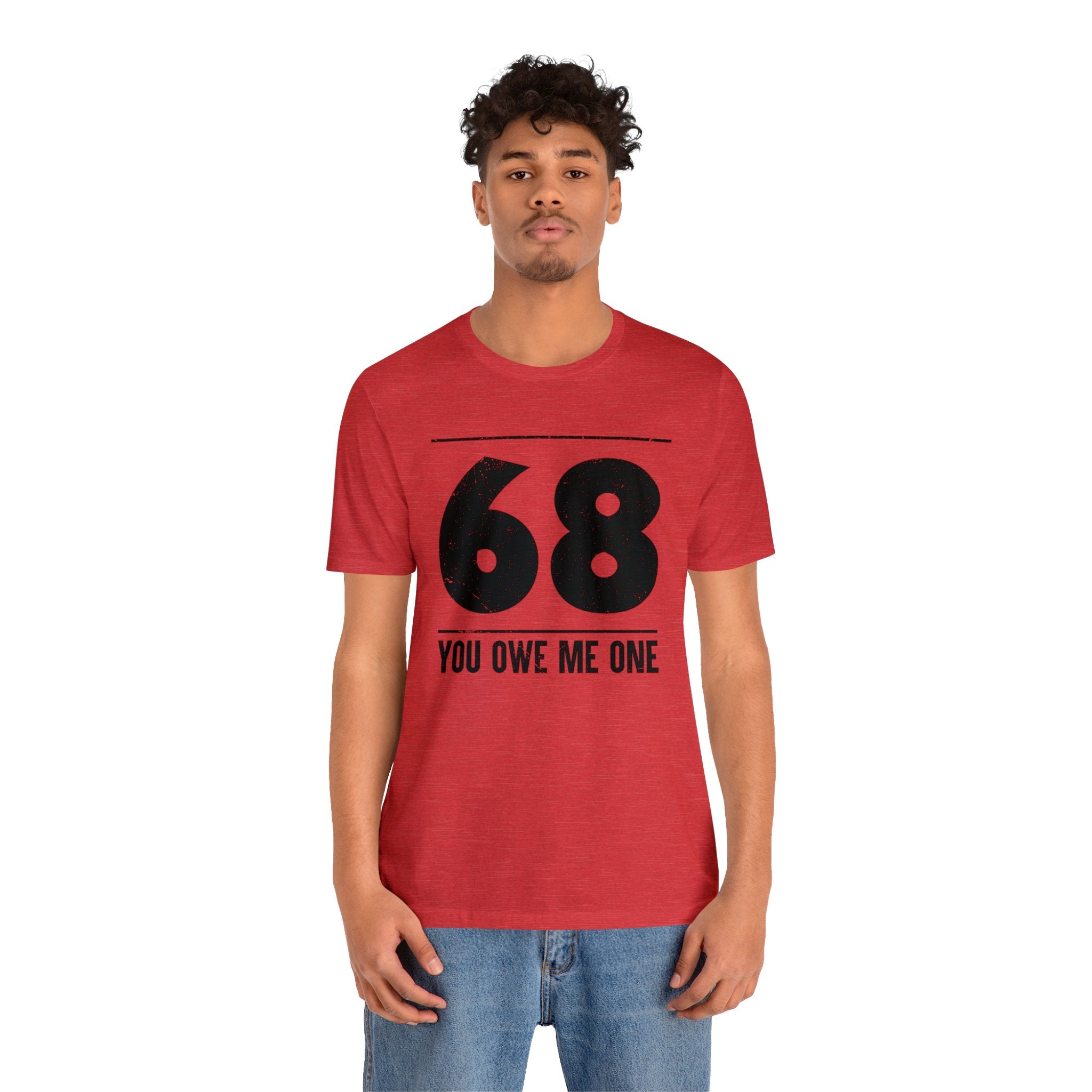 A man wearing a geeky red shirt with the number 68 You Owe Me One on it at an awesome deal.