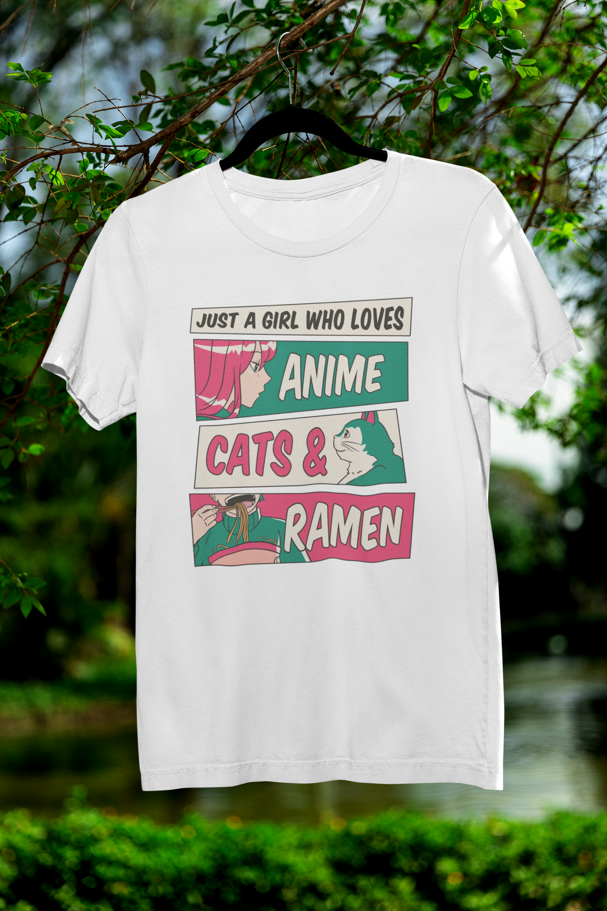 'Just a Girl Who Loves Anime, Cats & Ramen' t-shirt in white, hanging outdoors among green trees