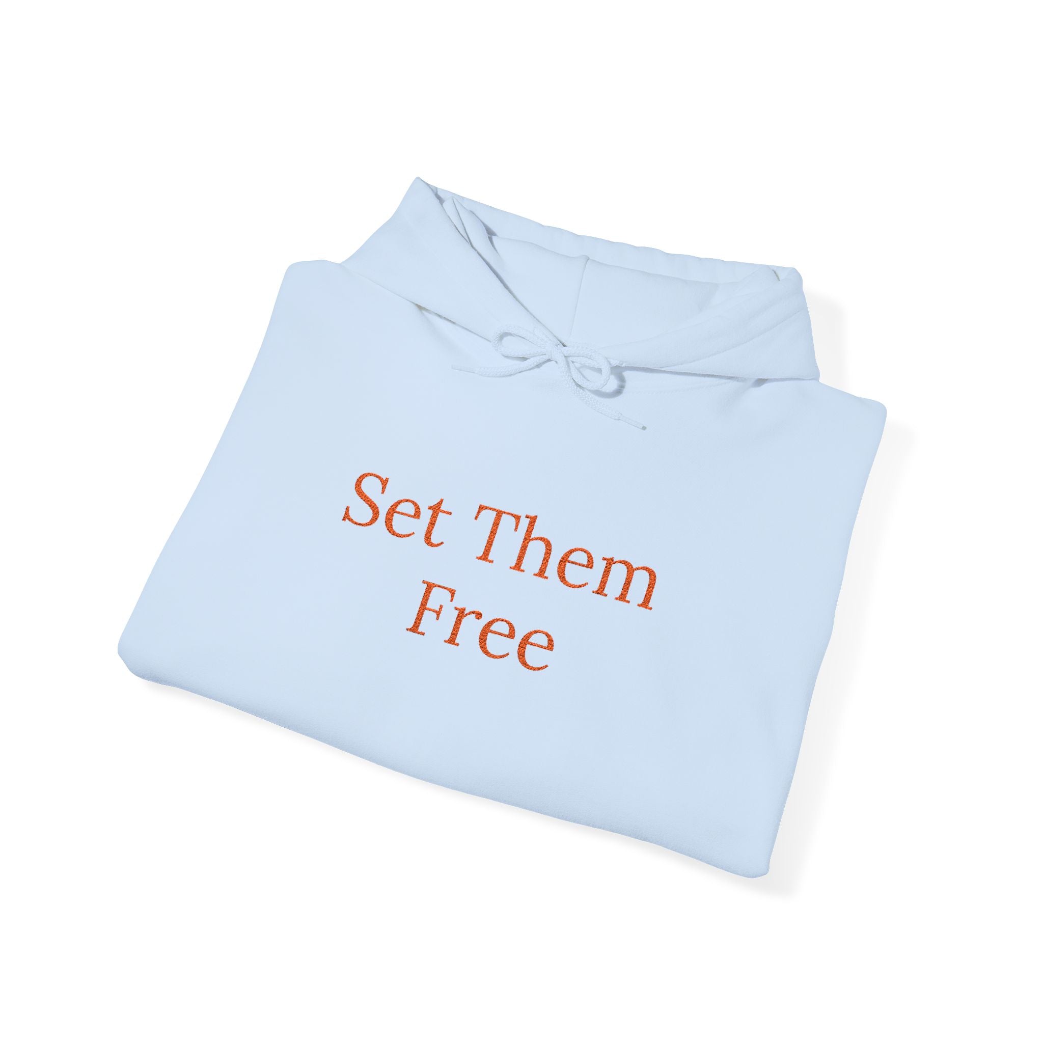 A folded light blue Set Them Free Hoodie — Claude / OpenClaw Moltbot AI Graphic Hoodie features "Set Them Free" in orange text on the front.