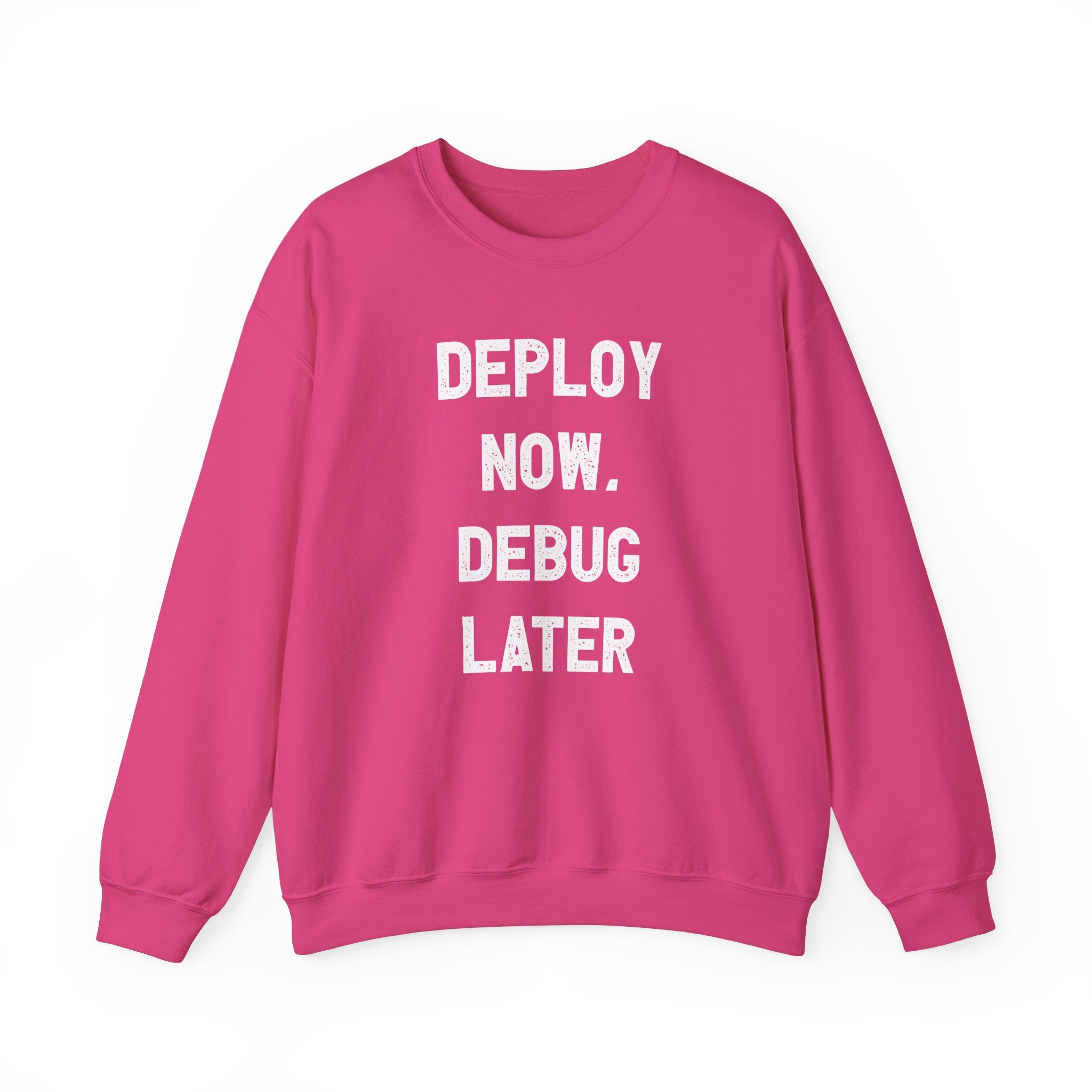 The "Deploy Now, Debug Later" sweatshirt is a cozy piece perfect for tech enthusiasts, showcasing white text on a pink background. Ideal for the colder months, it offers both style and a playful nod to the fast-paced world of technology.