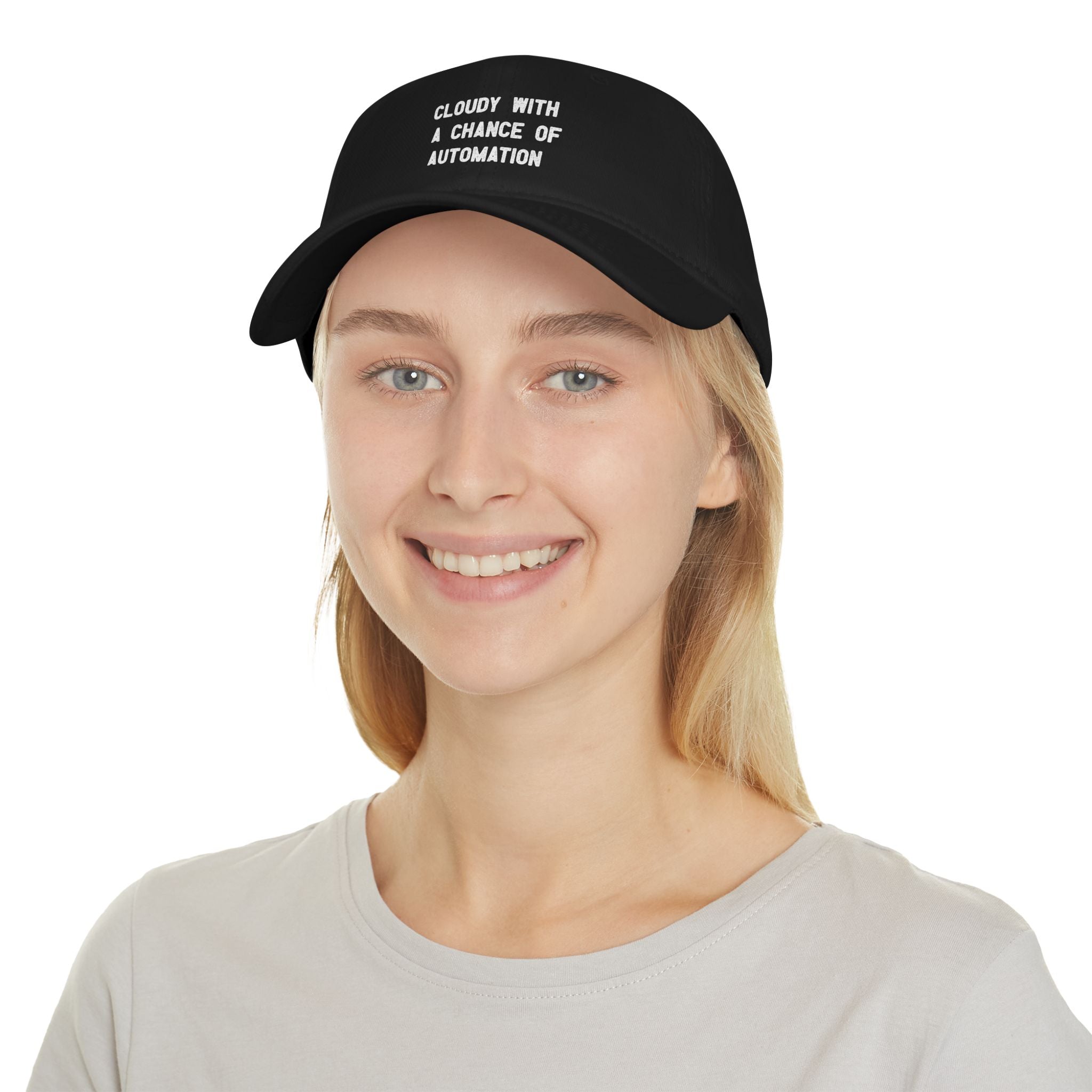 A person is smiling at the camera while wearing a "Cloudy With a Chance of Automation - Hat," which features reinforced stitching, and pairing it with a light gray t-shirt.