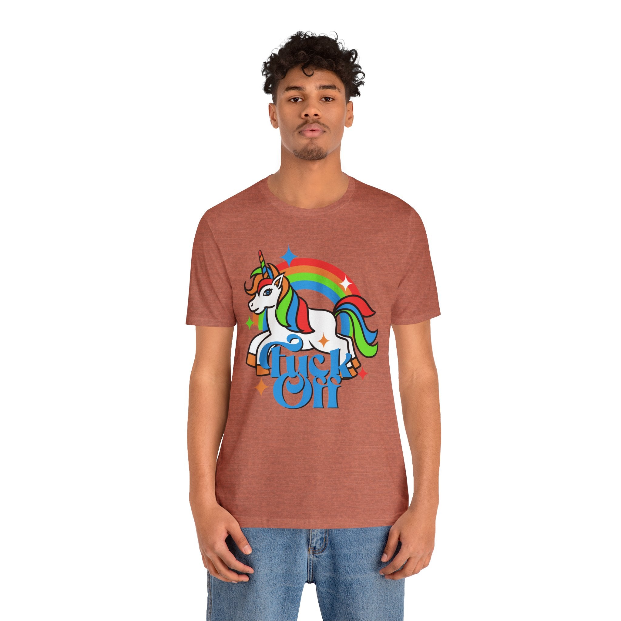 Young man in a brown, cotton unisex F off T-shirt featuring a colorful unicorn and rainbow design with the quality print and the text "dream on.