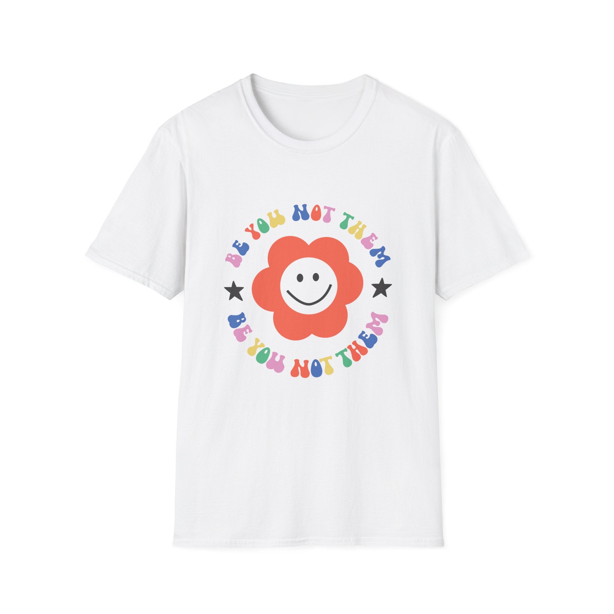 The "Be You Not Them T-Shirt" is a white top showcasing a cheerful red flower with the inspiring message "Be You Not Them" in vibrant colors, promoting joy and self-expression.