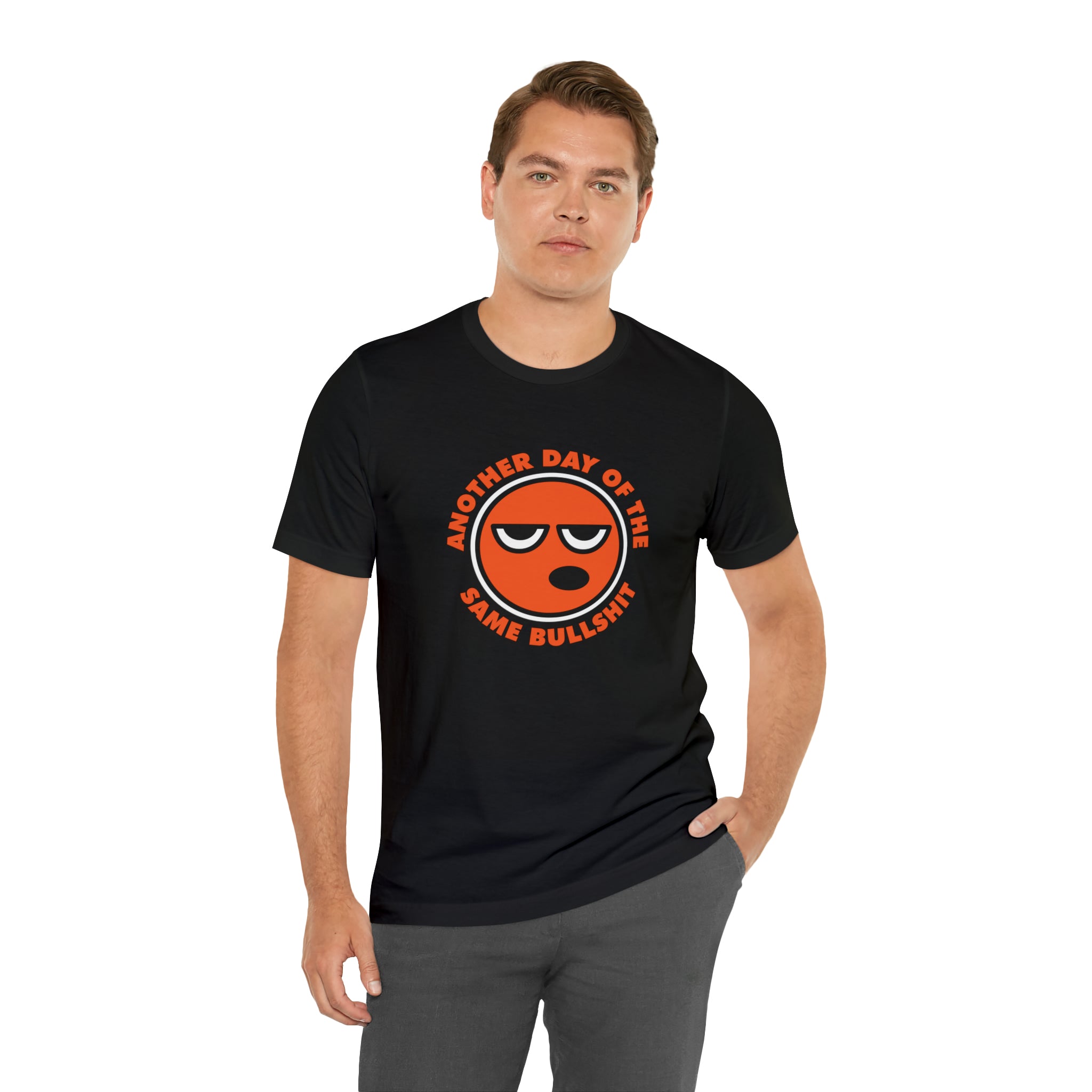 A man wearing a Another Day of the Same Bullshit T-shirt with an orange smiley face displaying a positive attitude.
