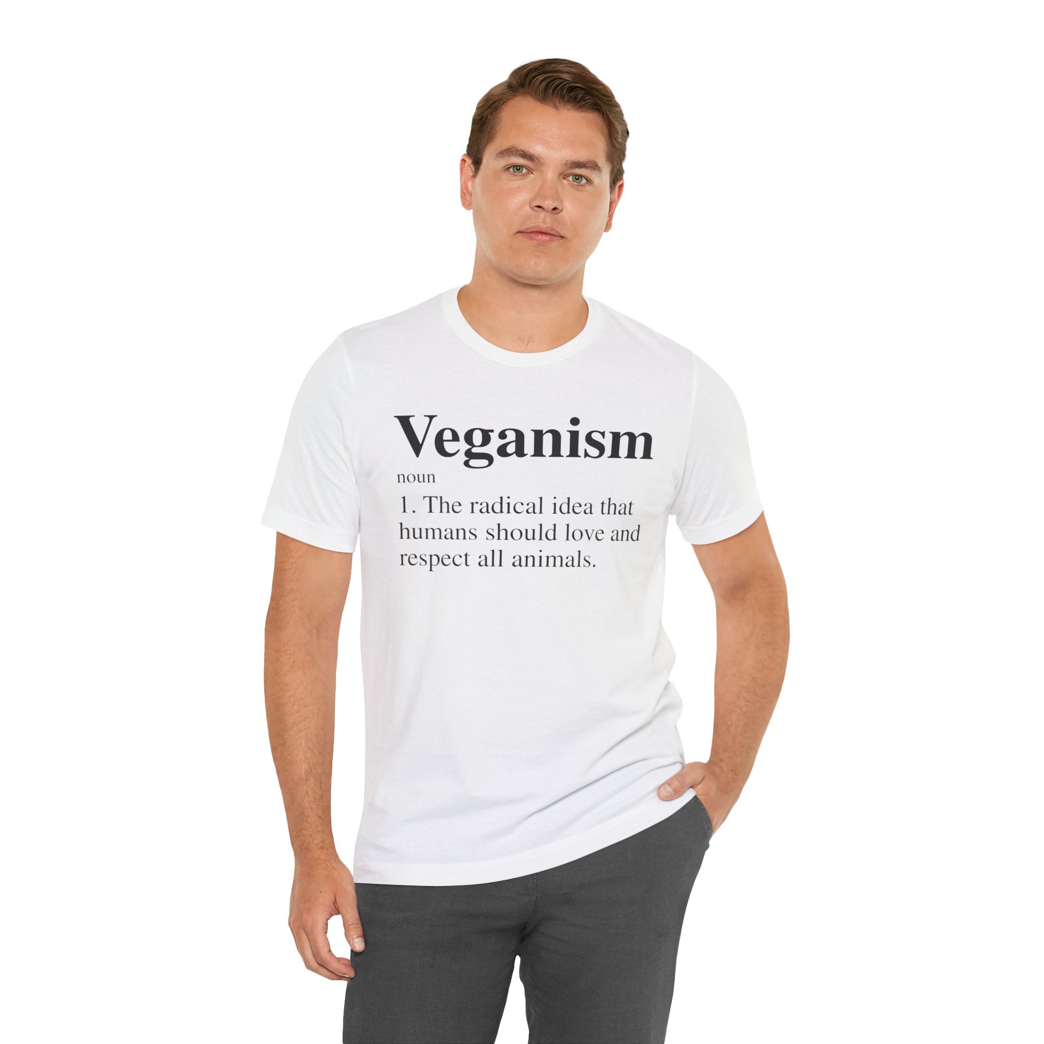 A man in a Veganism T-Shirt, with the word "veganism" and its definition printed on it, standing against a neutral background.