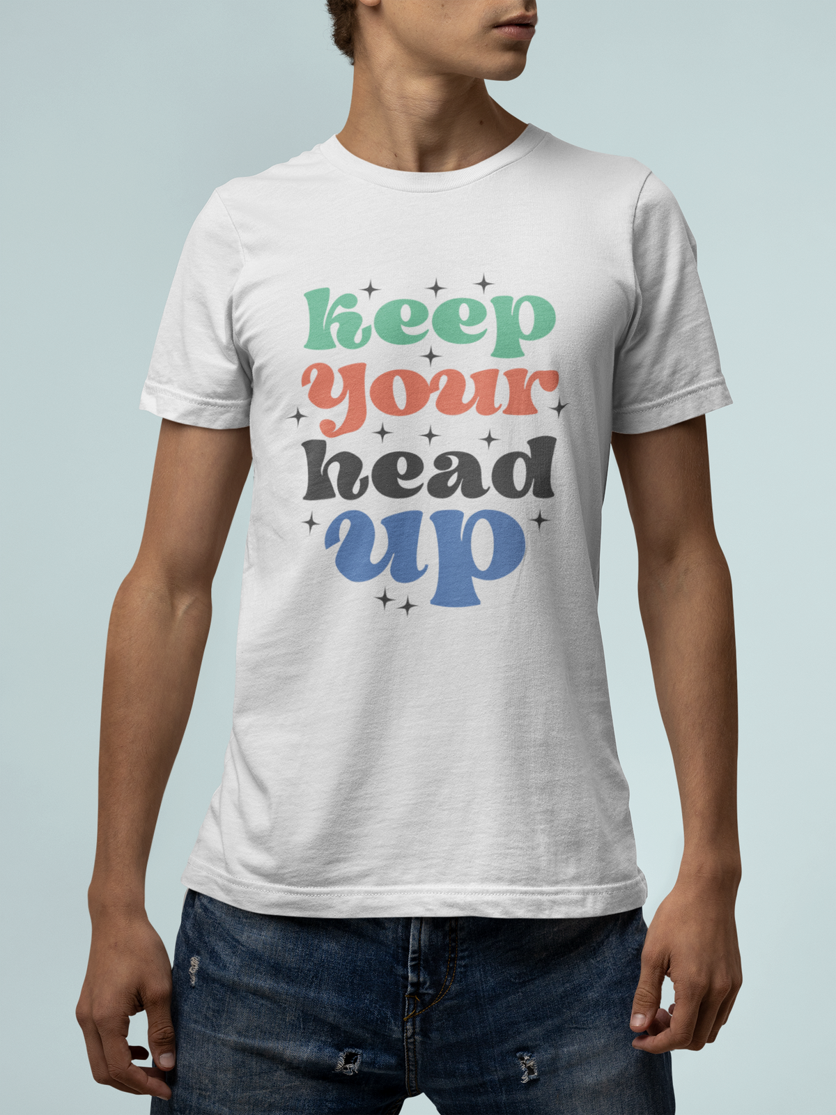 'Keep Your Head Up' t-shirt in white, man wearing it on teal background