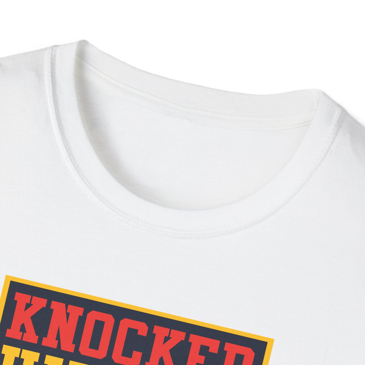 Close-up of "Knocked Him Out" robot boxing print on white t-shirt collar, retro arcade graphic detail