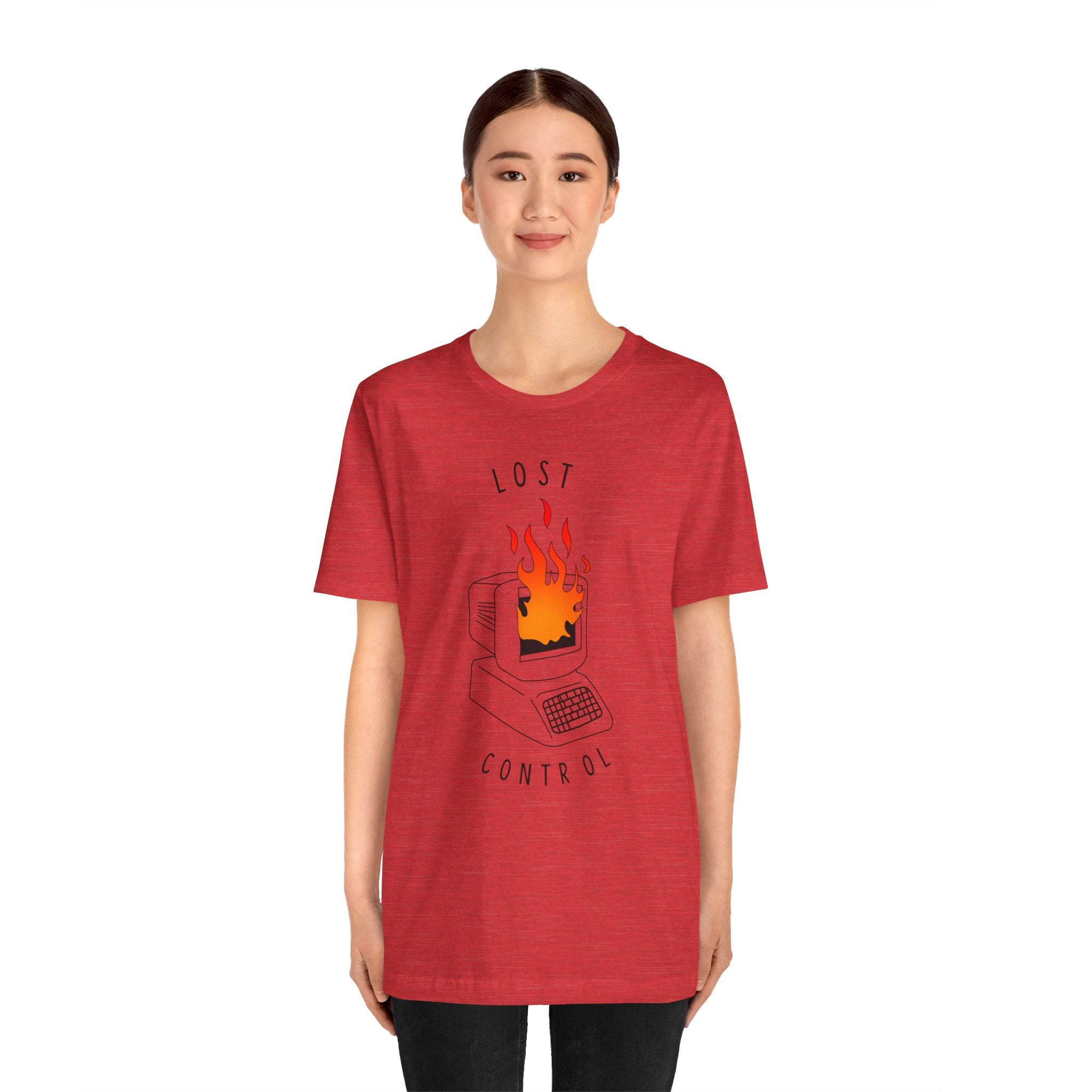 A person wearing the "Lost Control T-Shirt," a high-quality cotton garment designed for comfort, showcases an illustration of a computer on fire alongside the text "Lost Control.