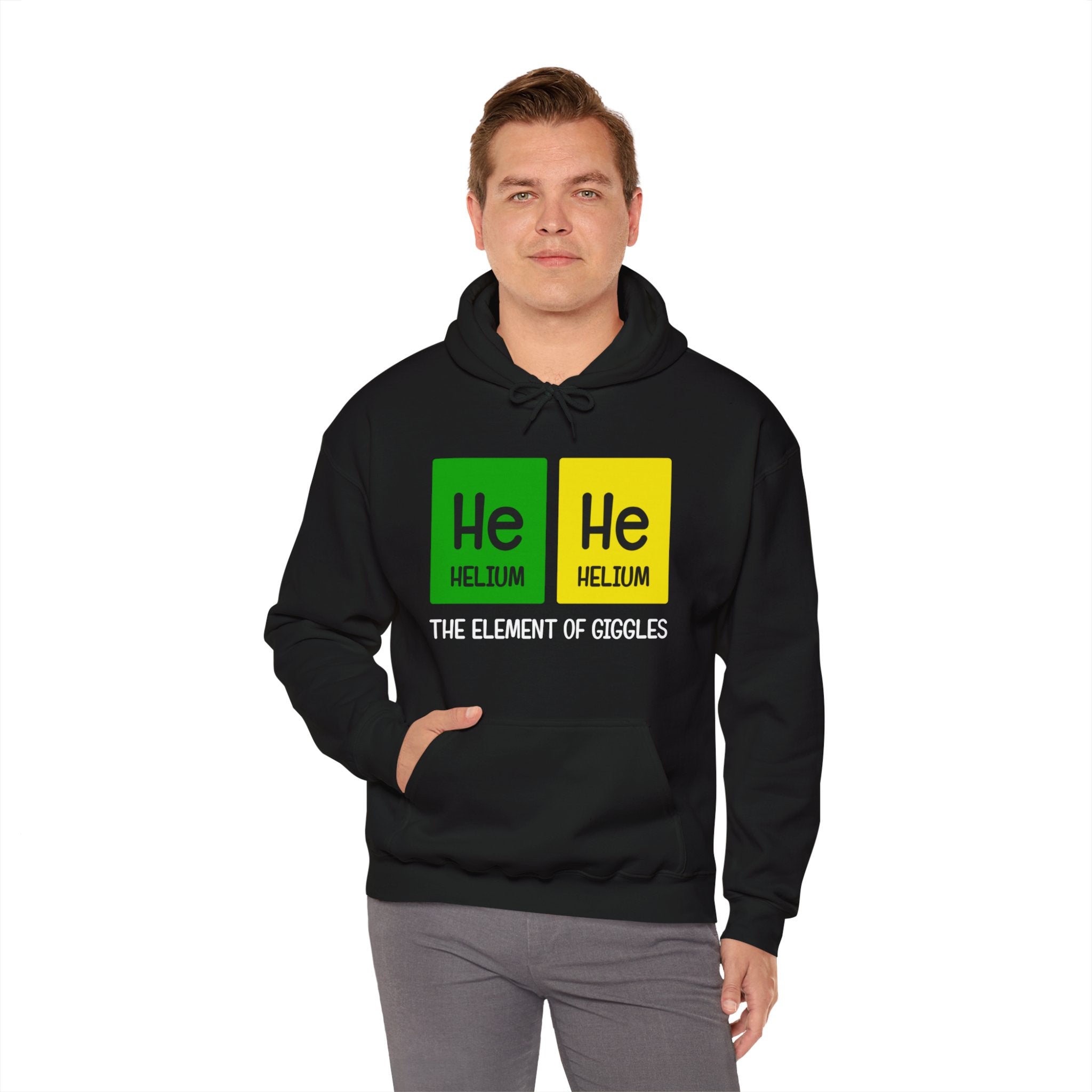 A person wearing a He-He - Hooded Sweatshirt with a periodic table design featuring Helium (He), whimsically labeled as "The Element of Giggles" by He-He designs.