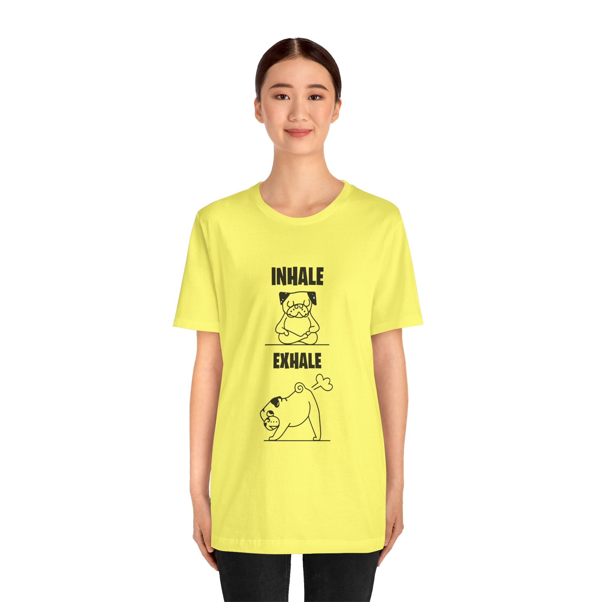 Young woman wearing a yellow unisex Dog Funny T shirt with an "inhale exhale" graphic featuring a cat and dog practicing yoga.