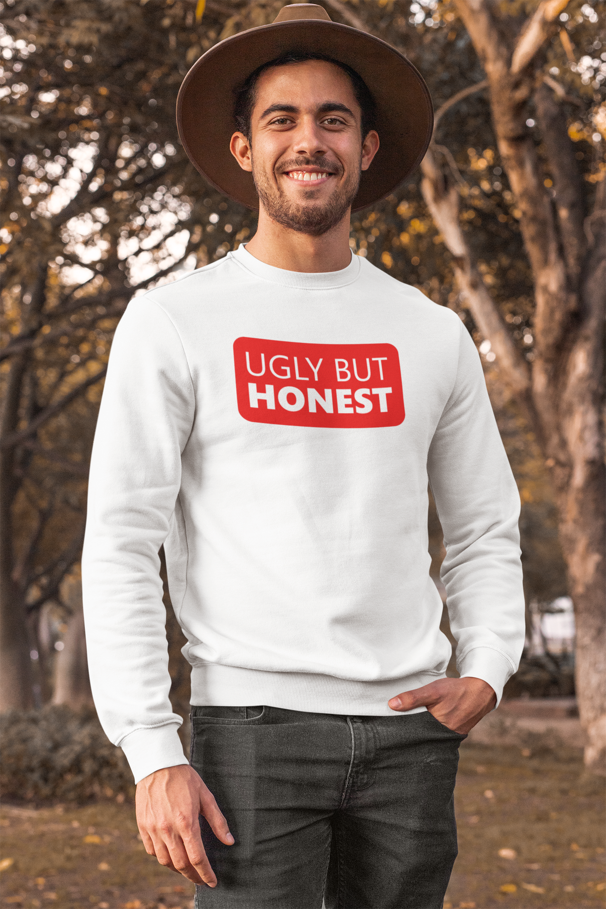'Ugly But Honest' sweatshirt in heather grey, bearded man wearing a hat outdoors, sarcastic gift