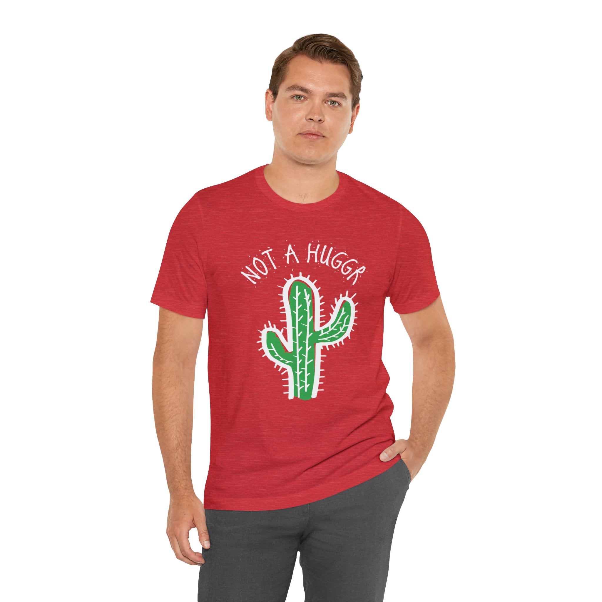 A trendy man wearing a red Not a Hugger T-Shirt with a cactus on it while respecting personal space.
