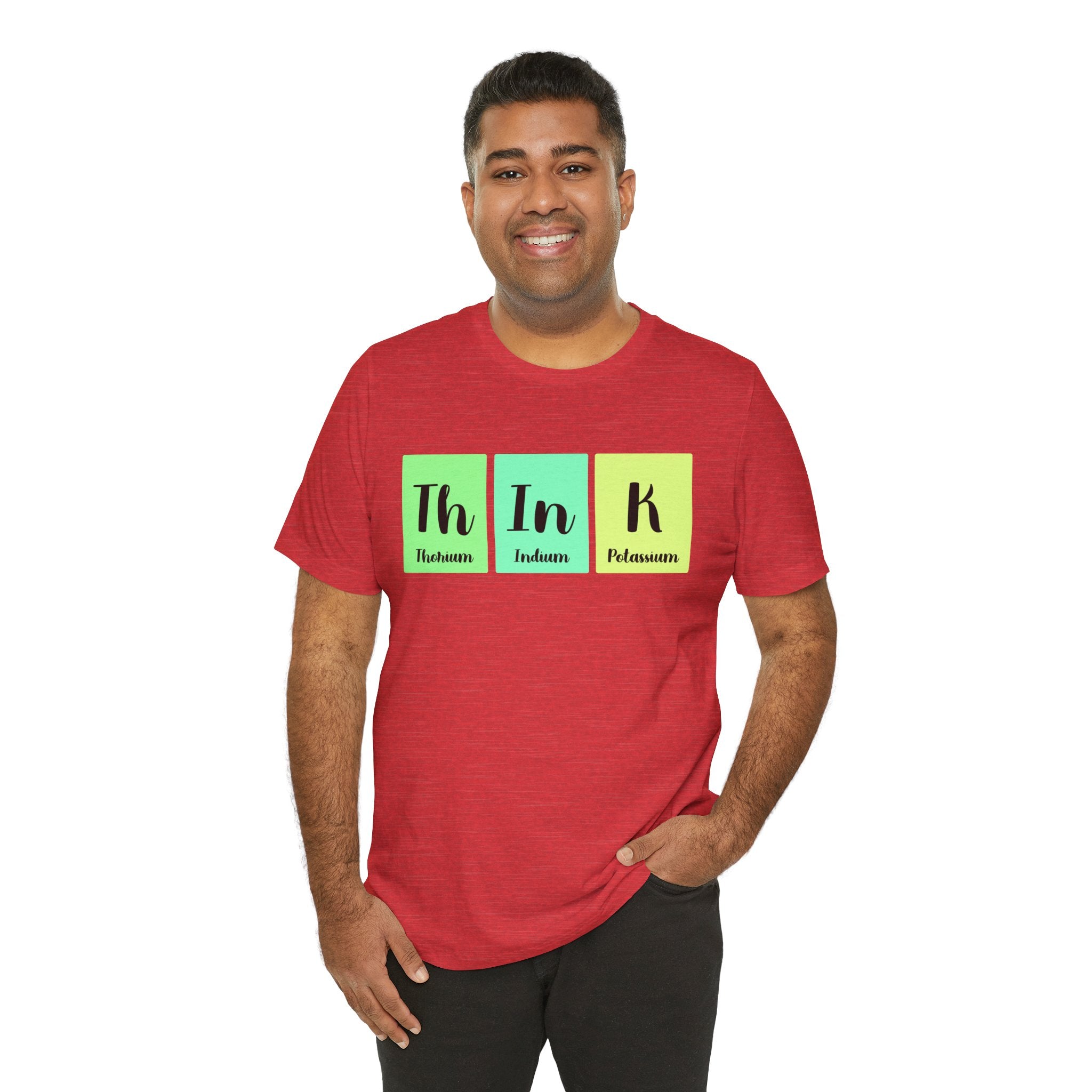 A man smiling, wearing a red unisex jersey tee with "Th-In-k" using elements from the periodic table printed on it.