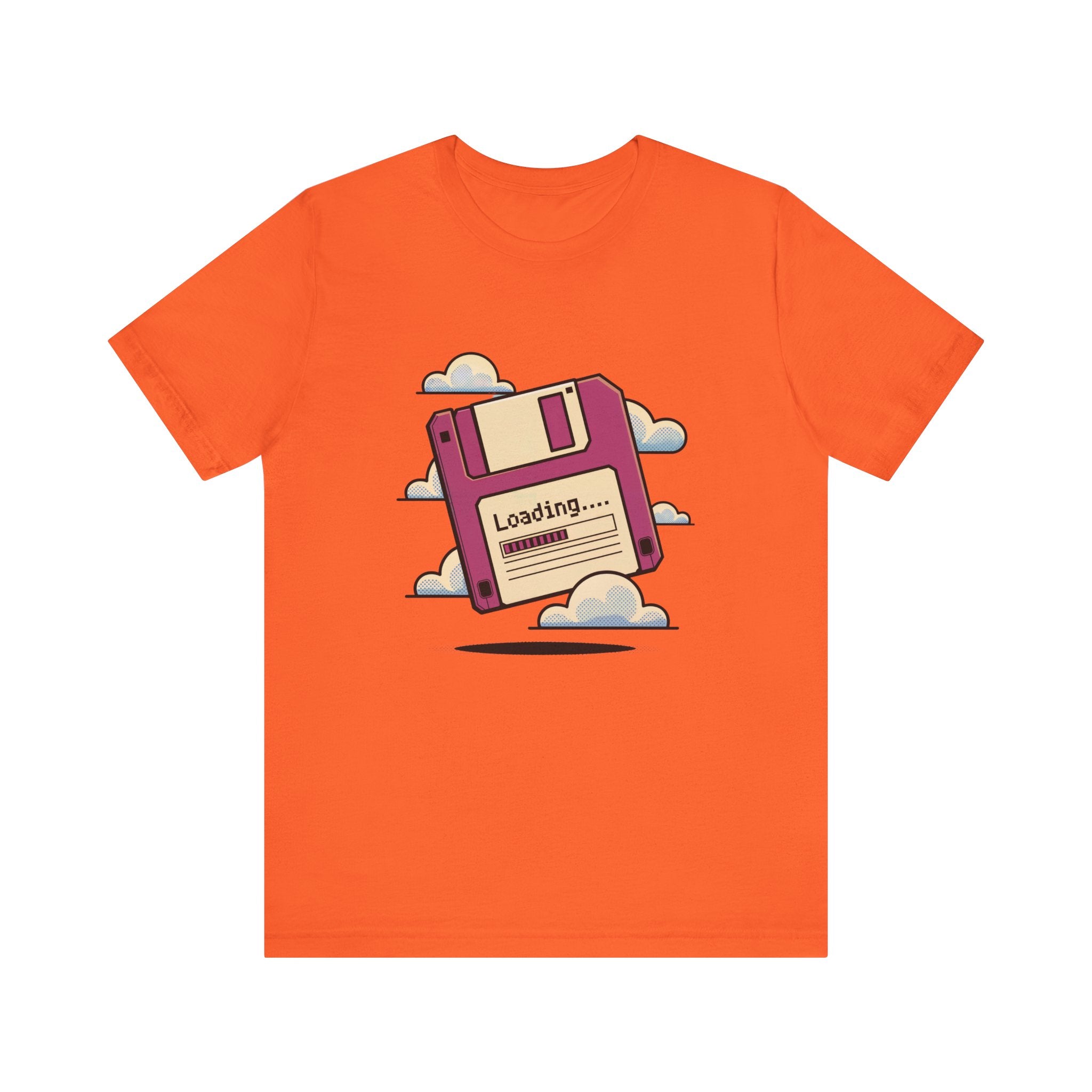 The Floppy disk -T Shirt is an orange cosmos cotton tee featuring a pink floppy disk illustration with "Loading..." text, surrounded by clouds.
