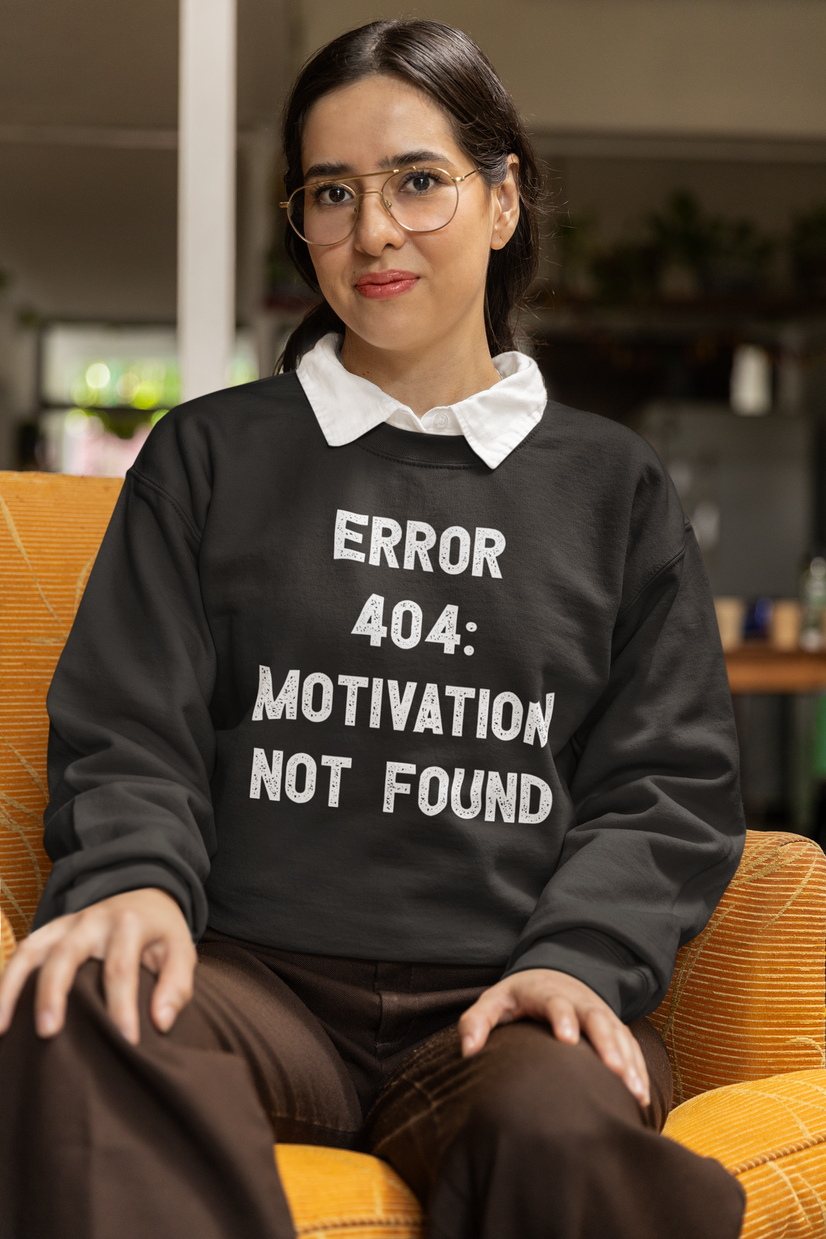 'Error 404 Motivation Not Found' sweatshirt in black, woman sitting indoors, funny programmer sweatshirt