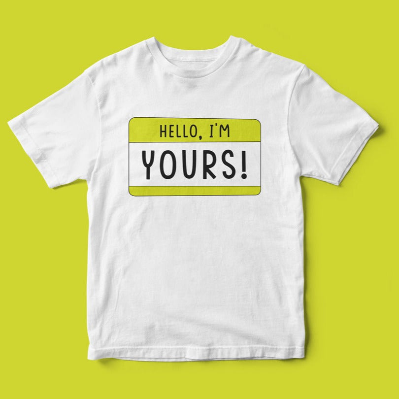 Geeky Hello, I'm YOURS T-Shirt on a yellow background with a badge design that reads "hello, i'm yours!" in black and yellow.