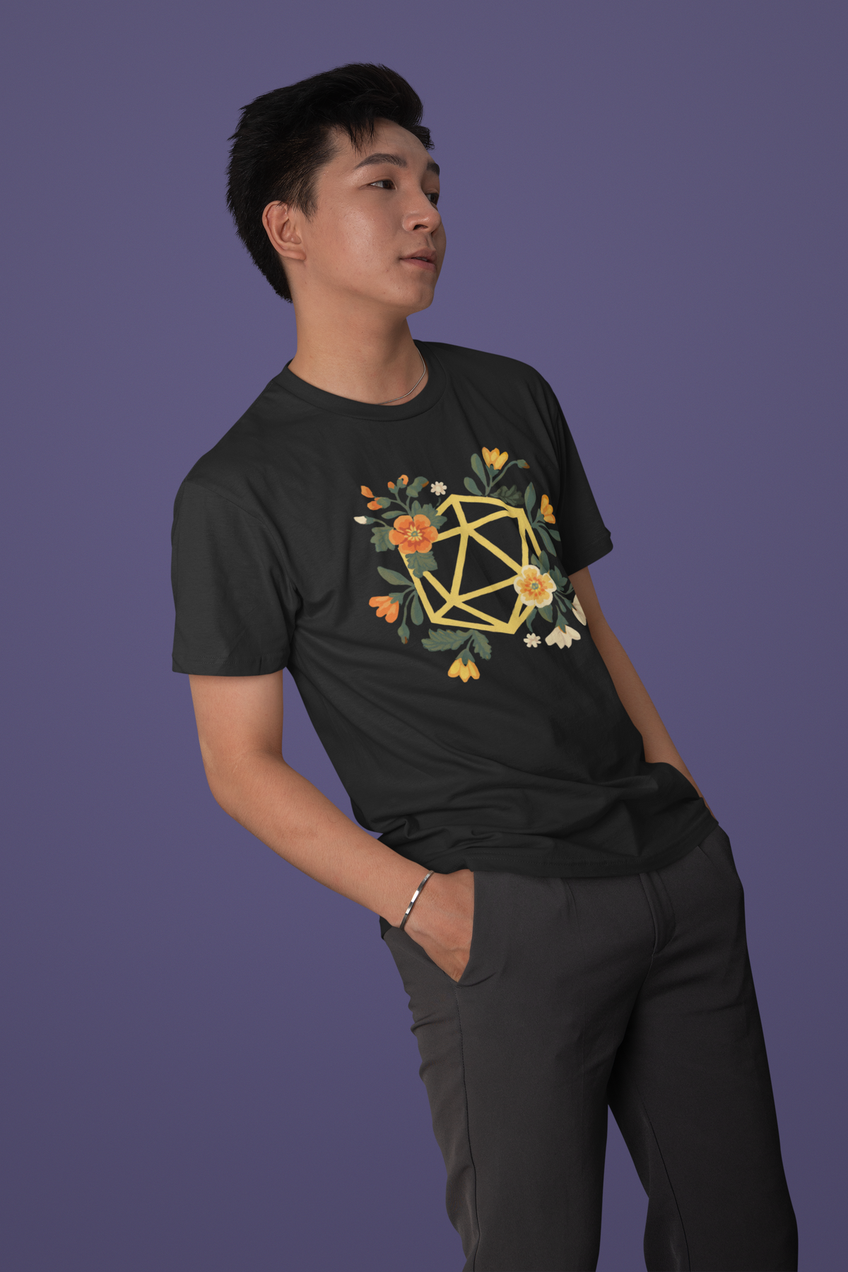 Flower Polyhedron T-Shirt in black, man wearing it against purple backdrop, floral polyhedron dnd tee
