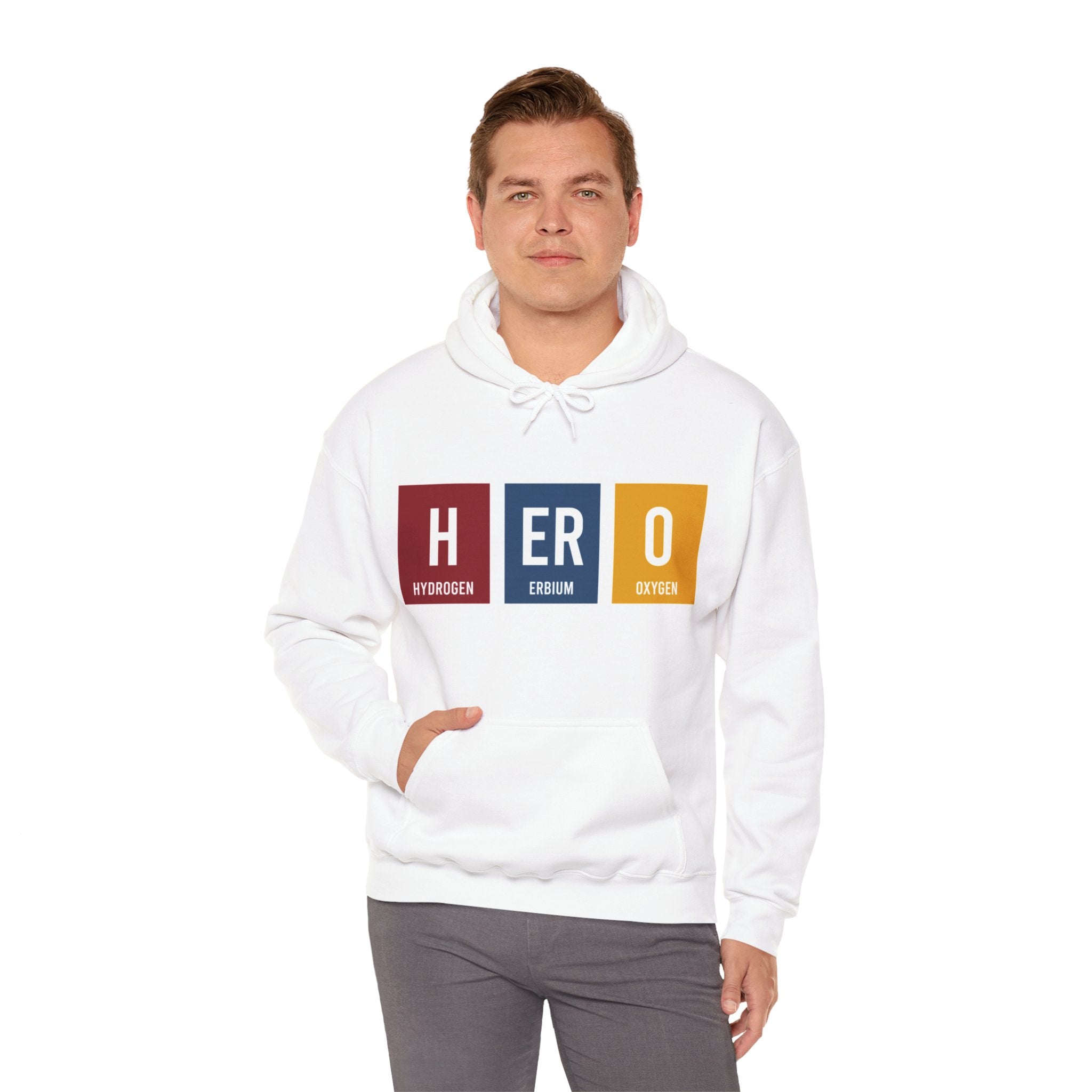 A person wearing a white HERO - Hooded Sweatshirt stands with their hand in the hoodie pocket, embodying subtle heroism.