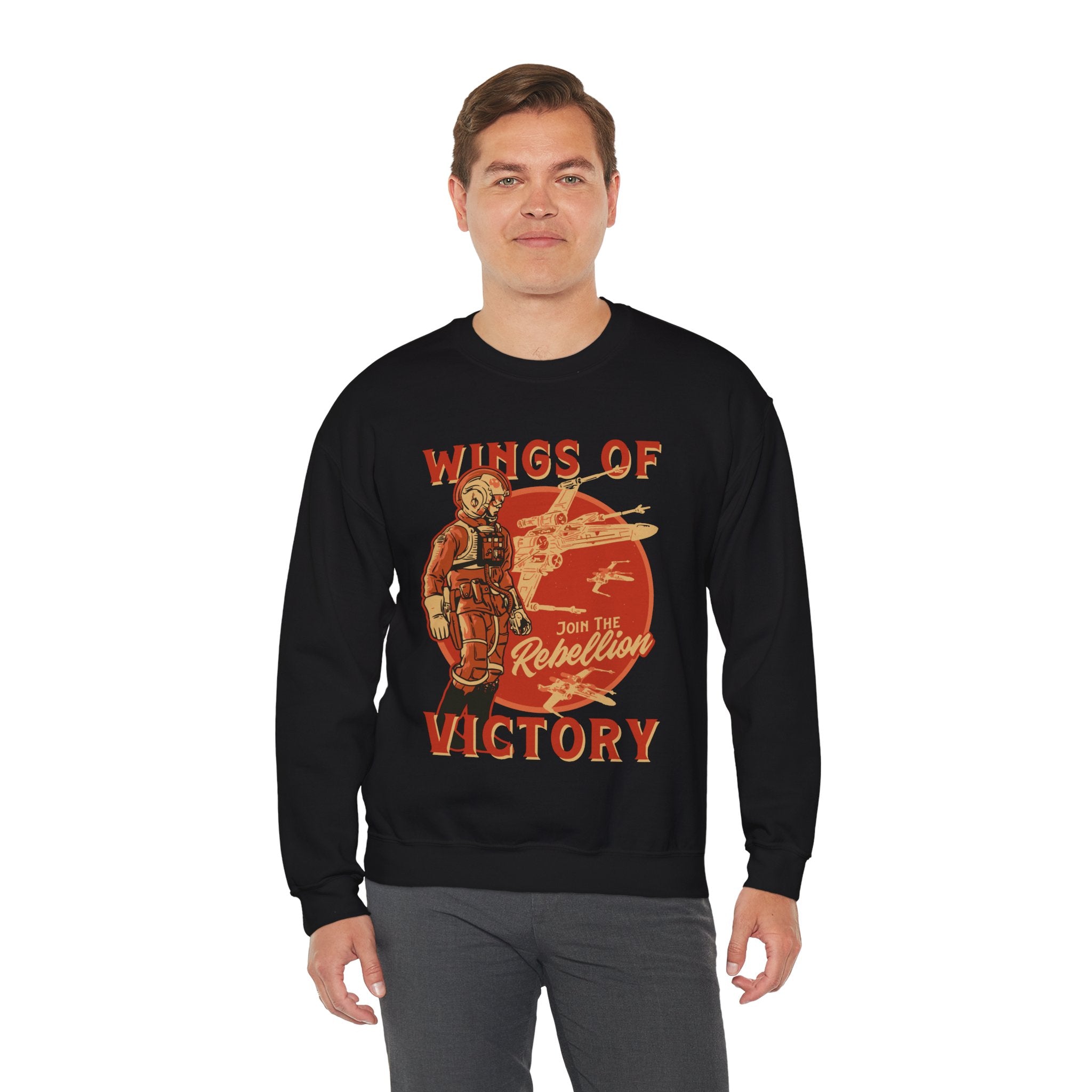 A person wearing a comfortable black Wings of Victory - Sweatshirt with a "Join the Rebellion" design featuring a fighter pilot and spacecraft.