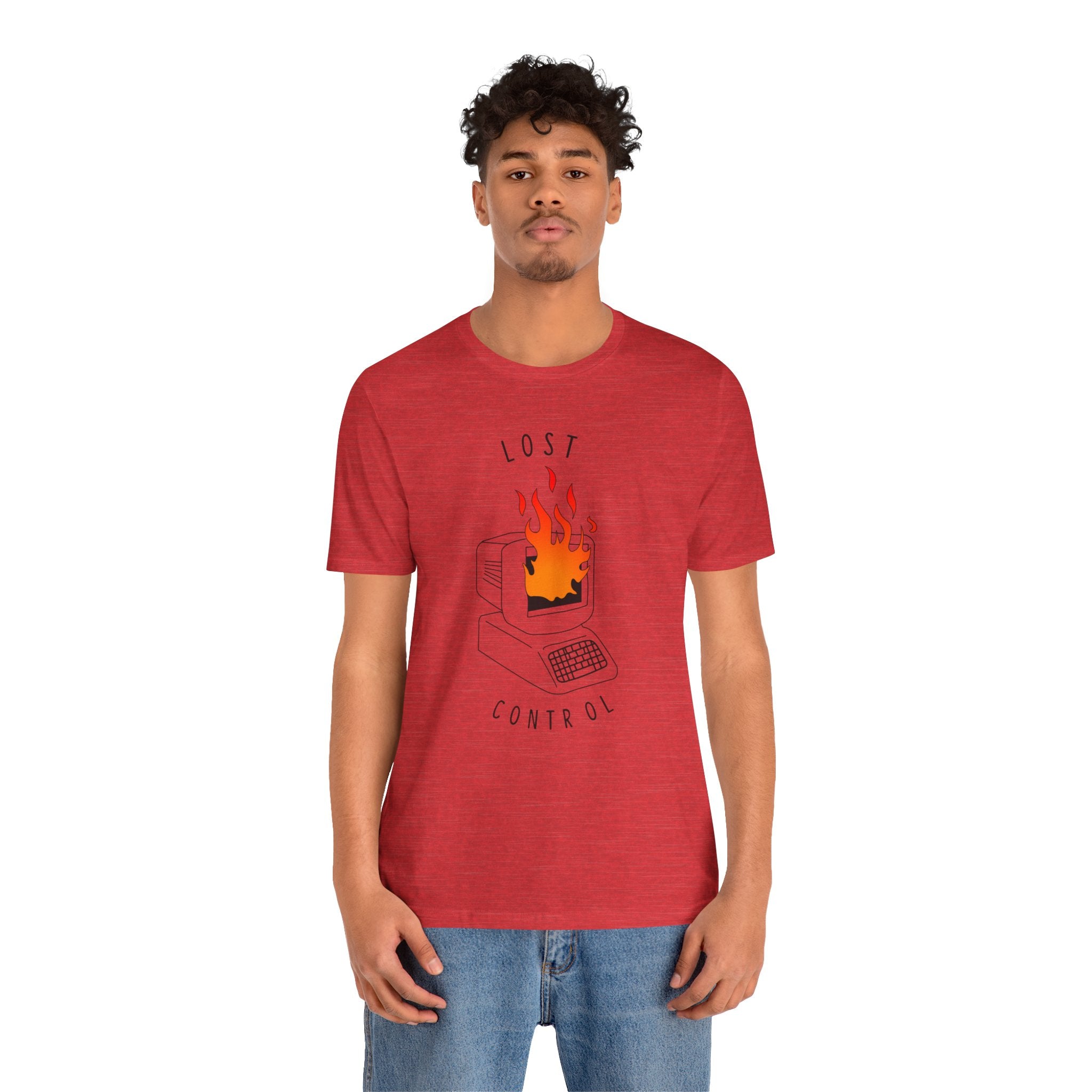 A person wearing the premium Lost Control T-Shirt, featuring a graphic of a computer on fire, paired with comfortably fitting blue jeans.