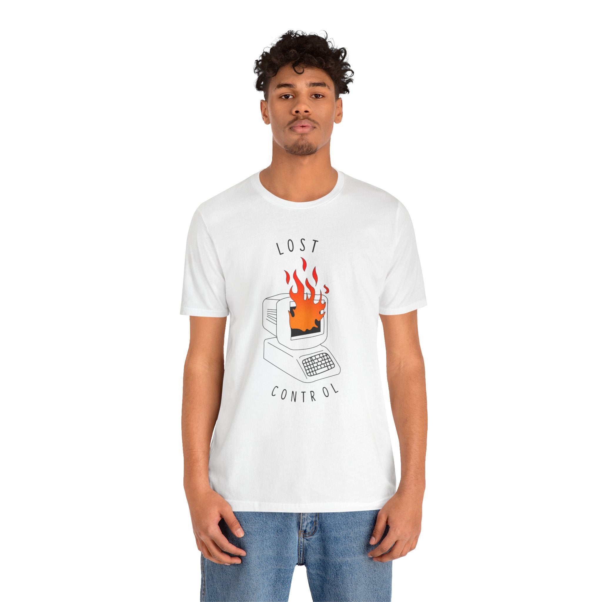 The Lost Control T-shirt, crafted from premium cotton and featuring a bold graphic of a burning computer on its white fabric, offers both comfort and style. Combined with blue jeans, it creates an effortlessly fashionable outfit.