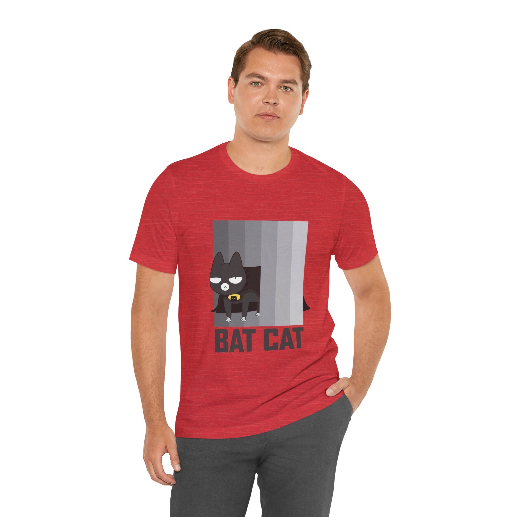 Man in red BATCAT T-Shirt with a "Batcat" graphic design, standing against a white background.