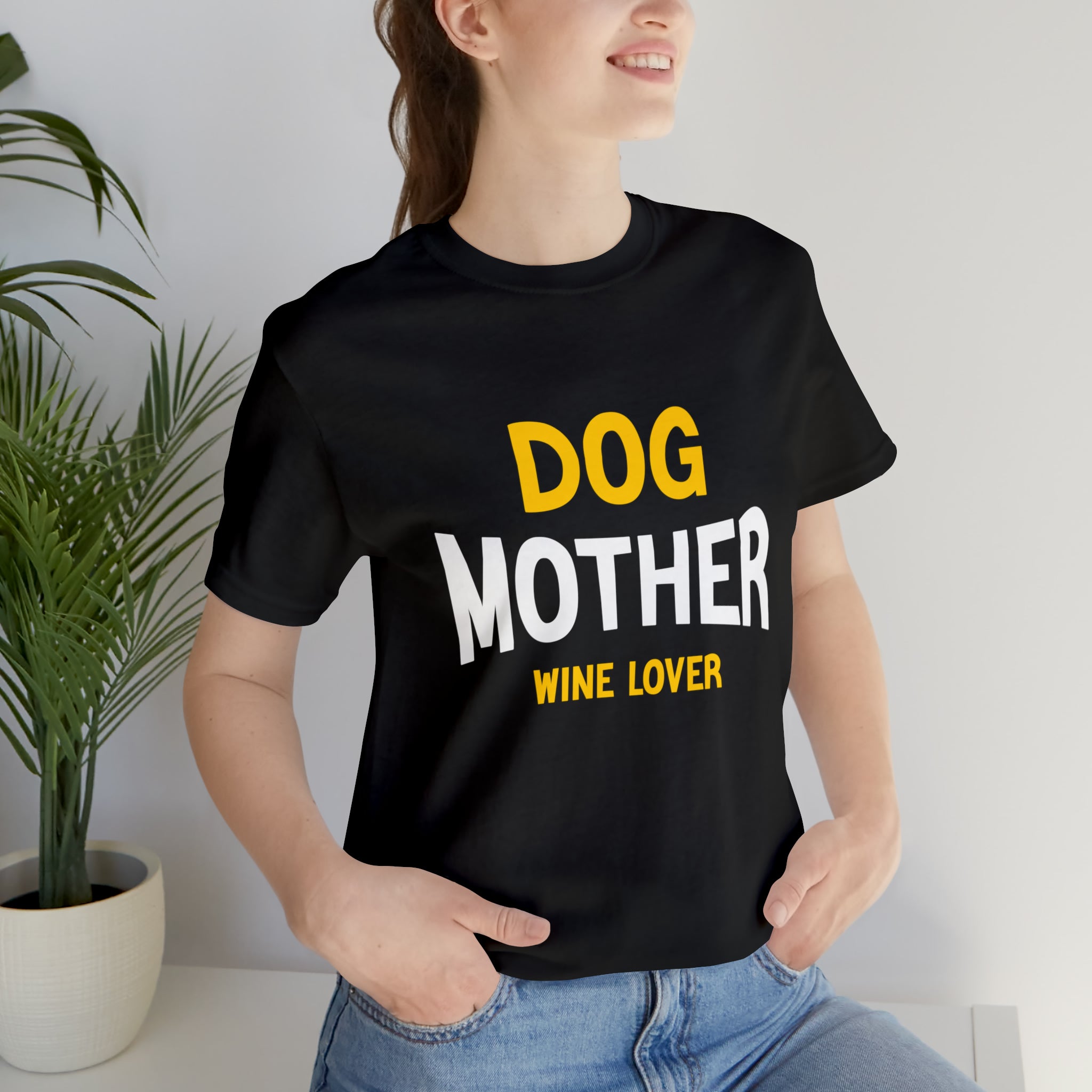 A woman wearing a black Dog Mother Wine Lover tee-shirt.
