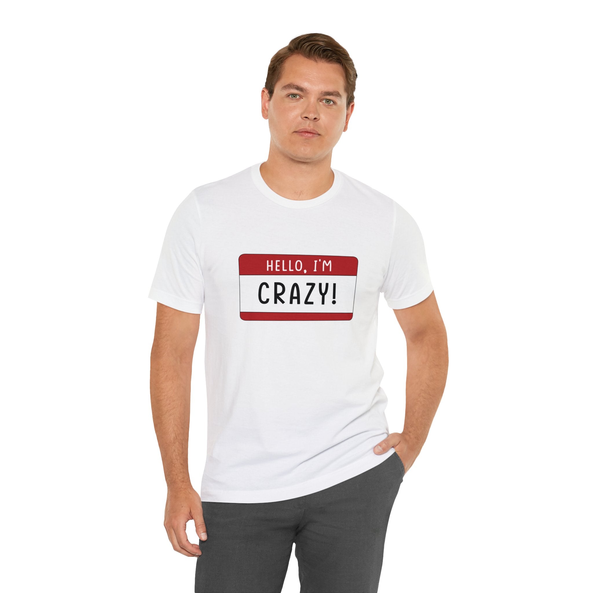 Man wearing a Hello, I'm CRAZY T-Shirt with a unique red name tag design that reads "hello, I'm crazy!" standing against a white background.