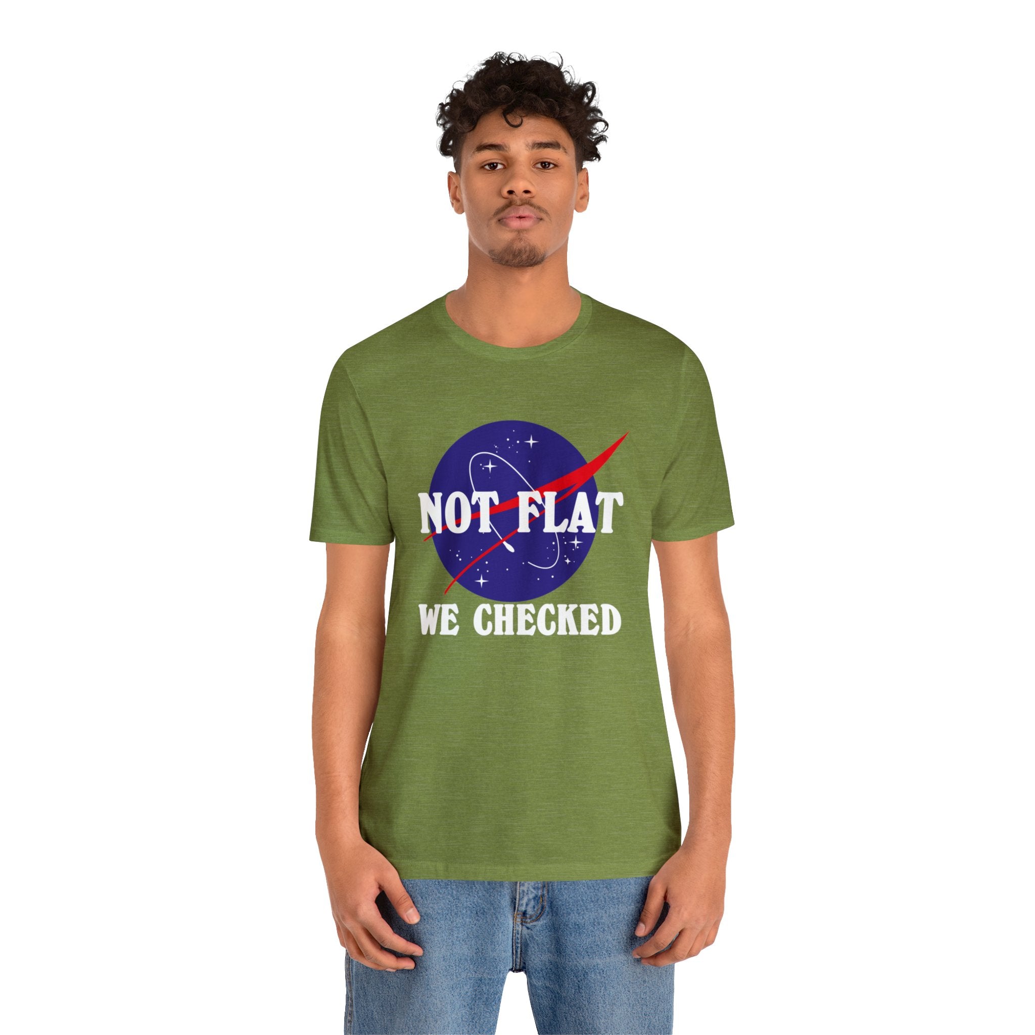 A man wearing a green "Earth Not Flat" t-shirt, showcasing his humor and scientific knowledge regarding the Earth's shape.